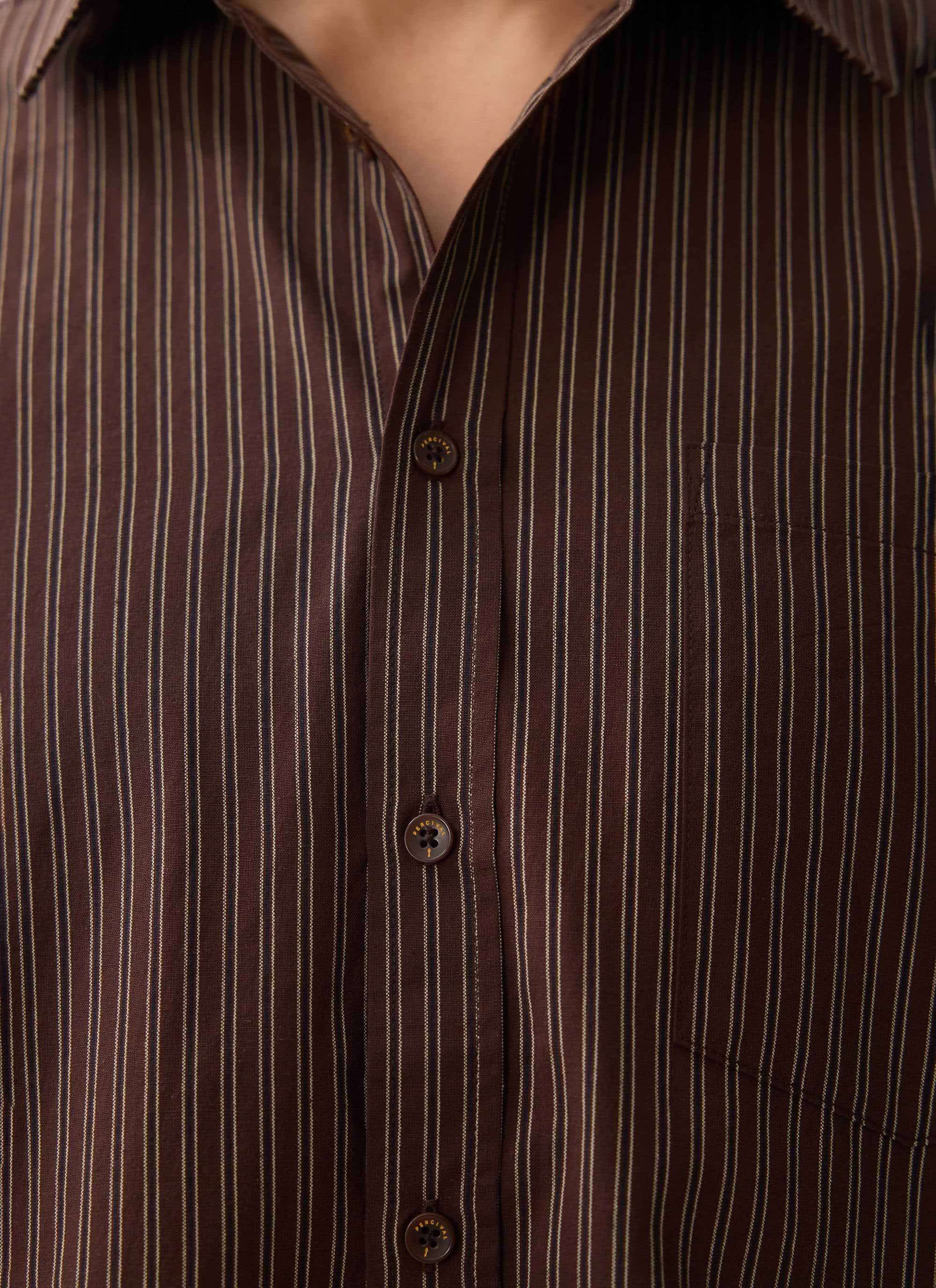 A close-up of the Percival Clancy Striped Long Sleeve Shirt in brown, showing the fine stripe detail and branded buttons.