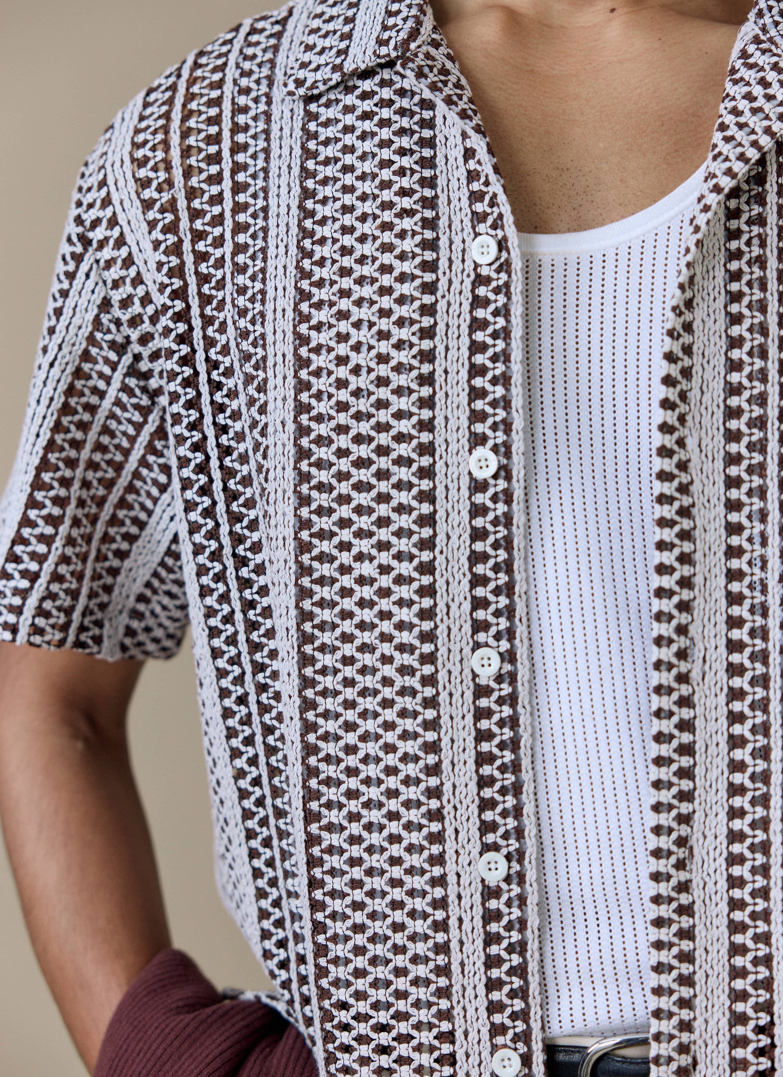 Close up of the Percival Hugh Crochet Boxy Shirt in brown and white, highlighting the striped knit and button-through front.