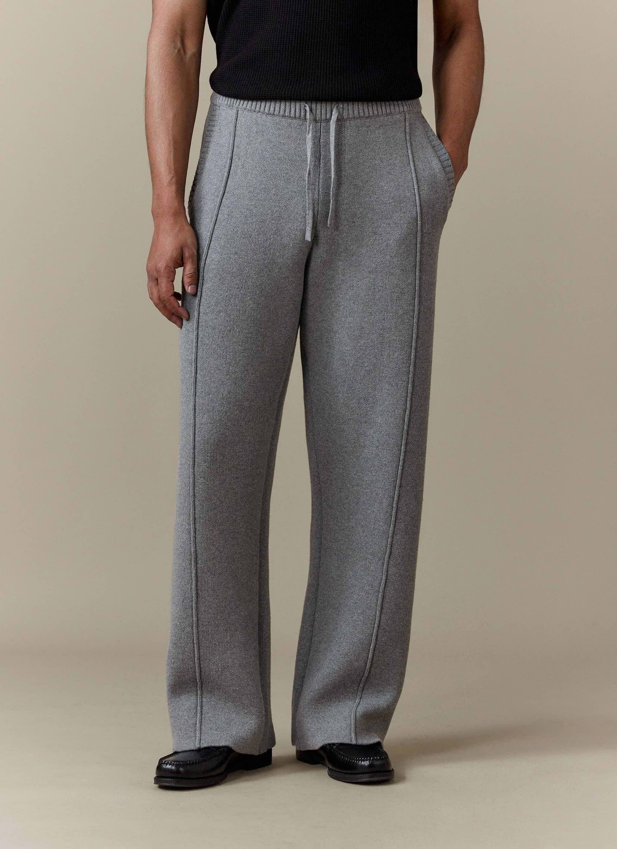 A model wears the grey cotton Chronicle Knitted Straight Leg Trackpant by Percival, showing the straight fit and seam detail.