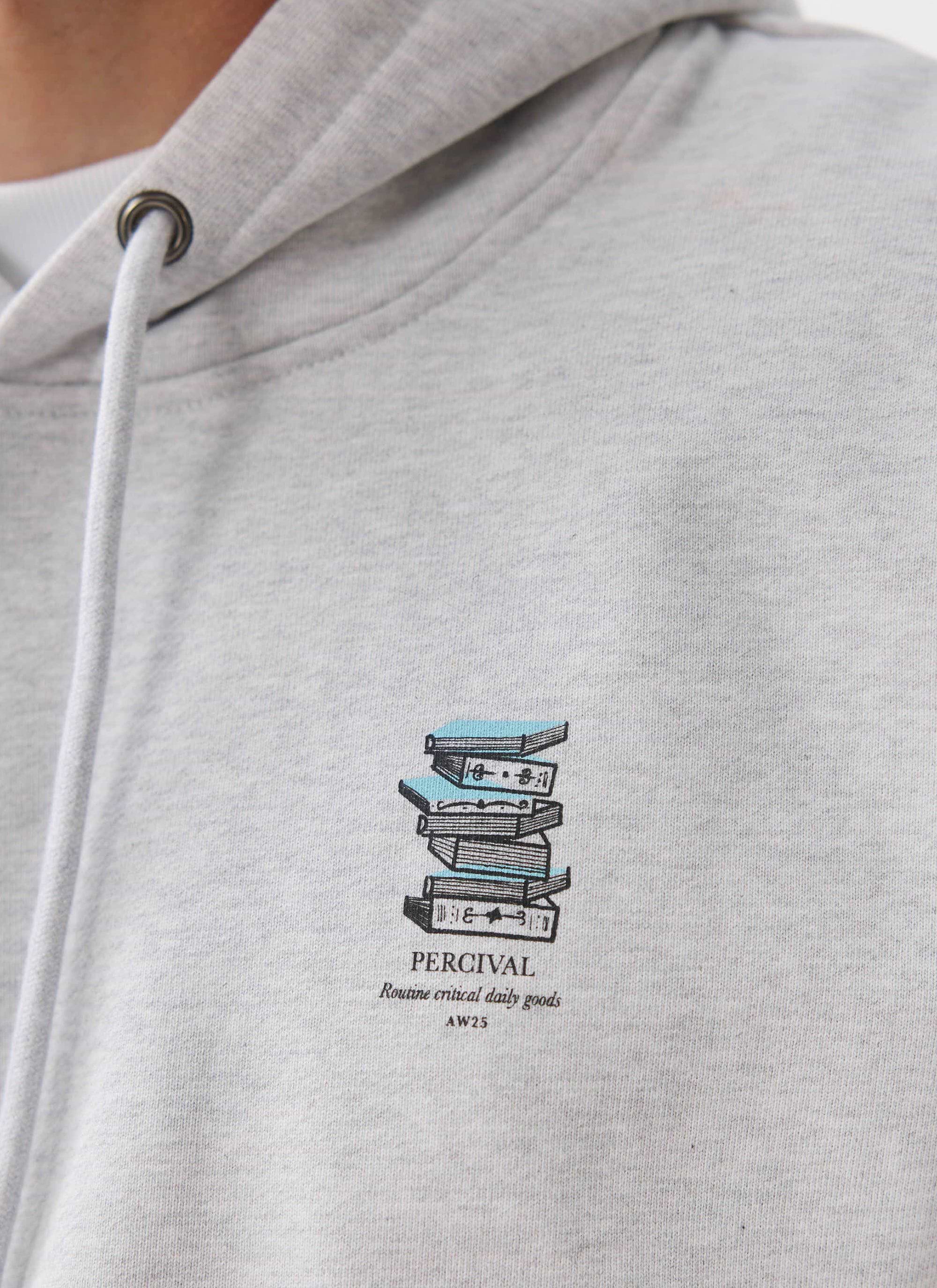 A close-up of the Percival Duke Hoodie in grey, highlighting the 'Routine Critical Daily Goods' book graphic on the chest.