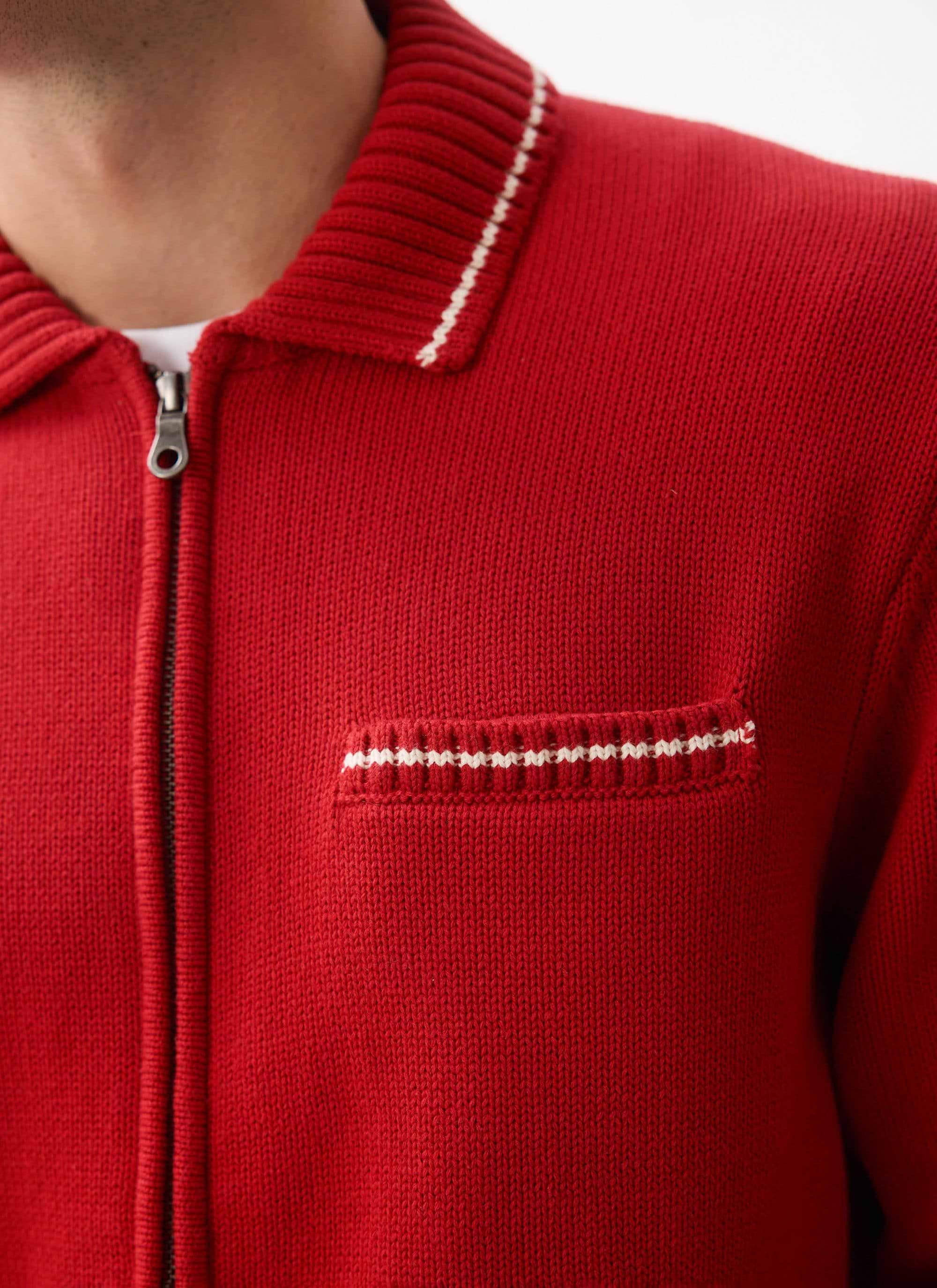 A close-up shot of the Percival Gardner Dense Knitted Zip Cardigan, showing its white stitch detailing on collar and pocket.