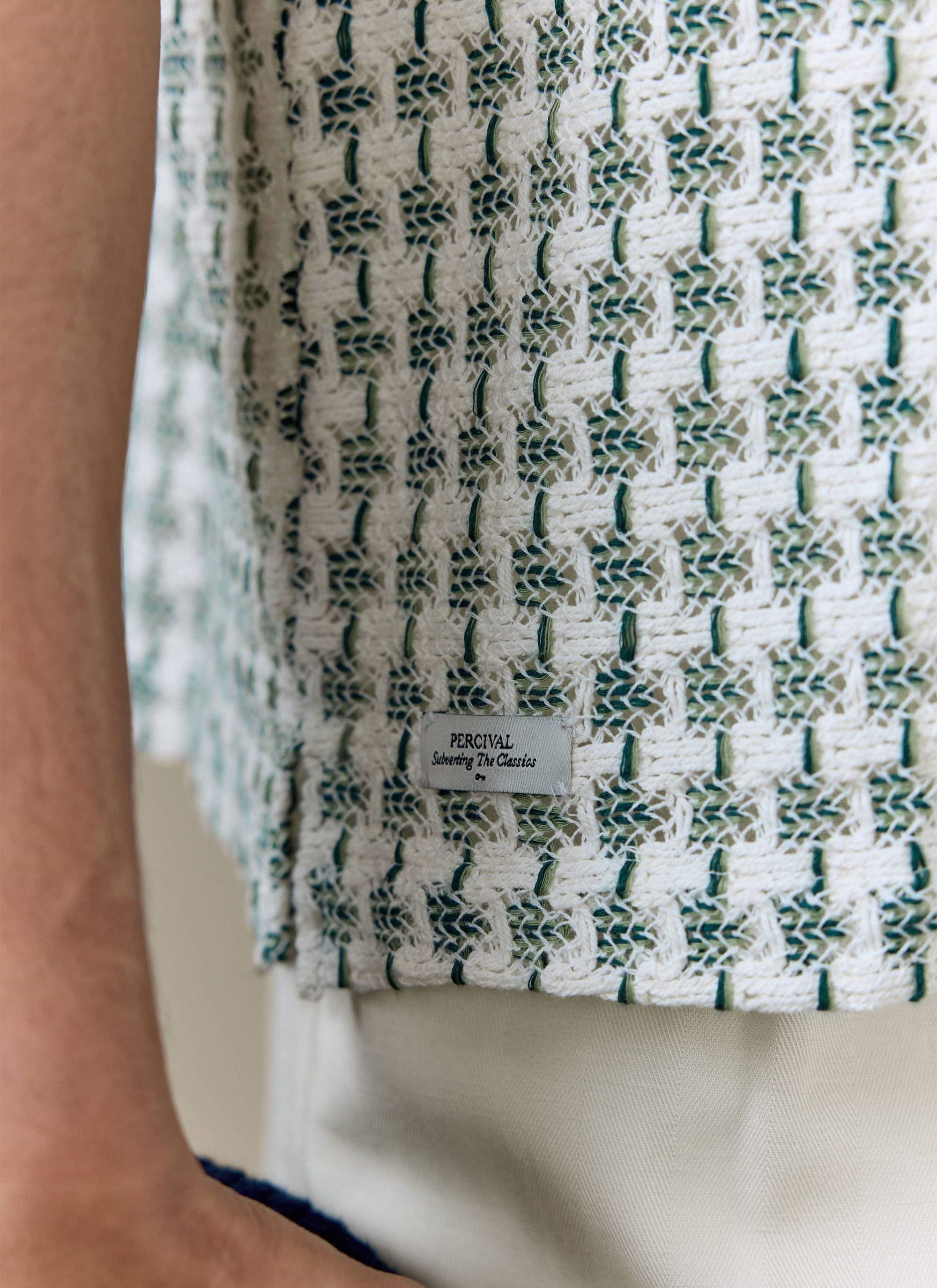 Close-up of the Percival Freddie Crochet Boxy Shirt in green, showing the textured cotton weave and branded side tag.