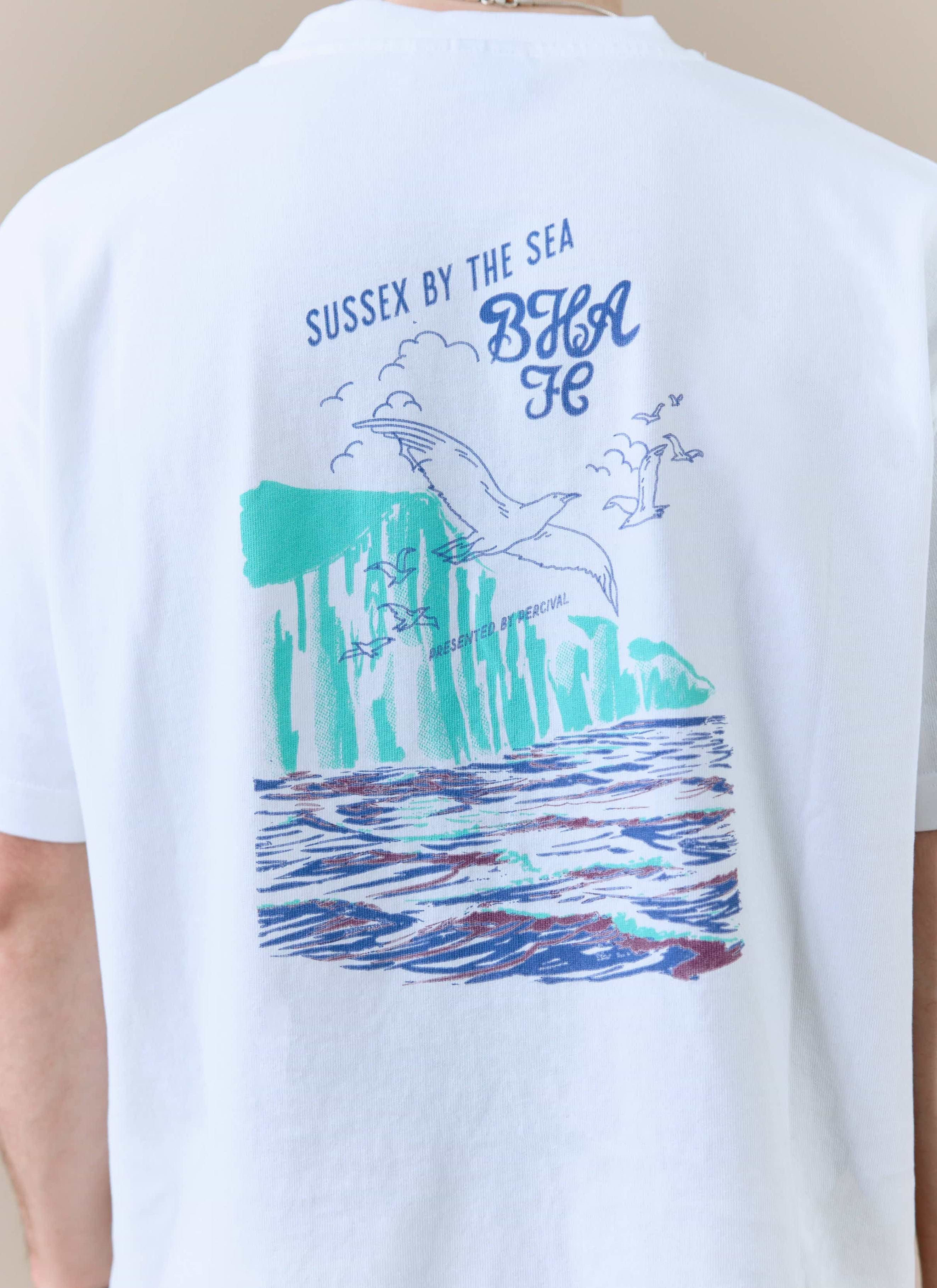 Close-up of the 'Sussex by the Sea' graphic on the back of the white Percival x Brighton & Hove Albion F.C. t-shirt.