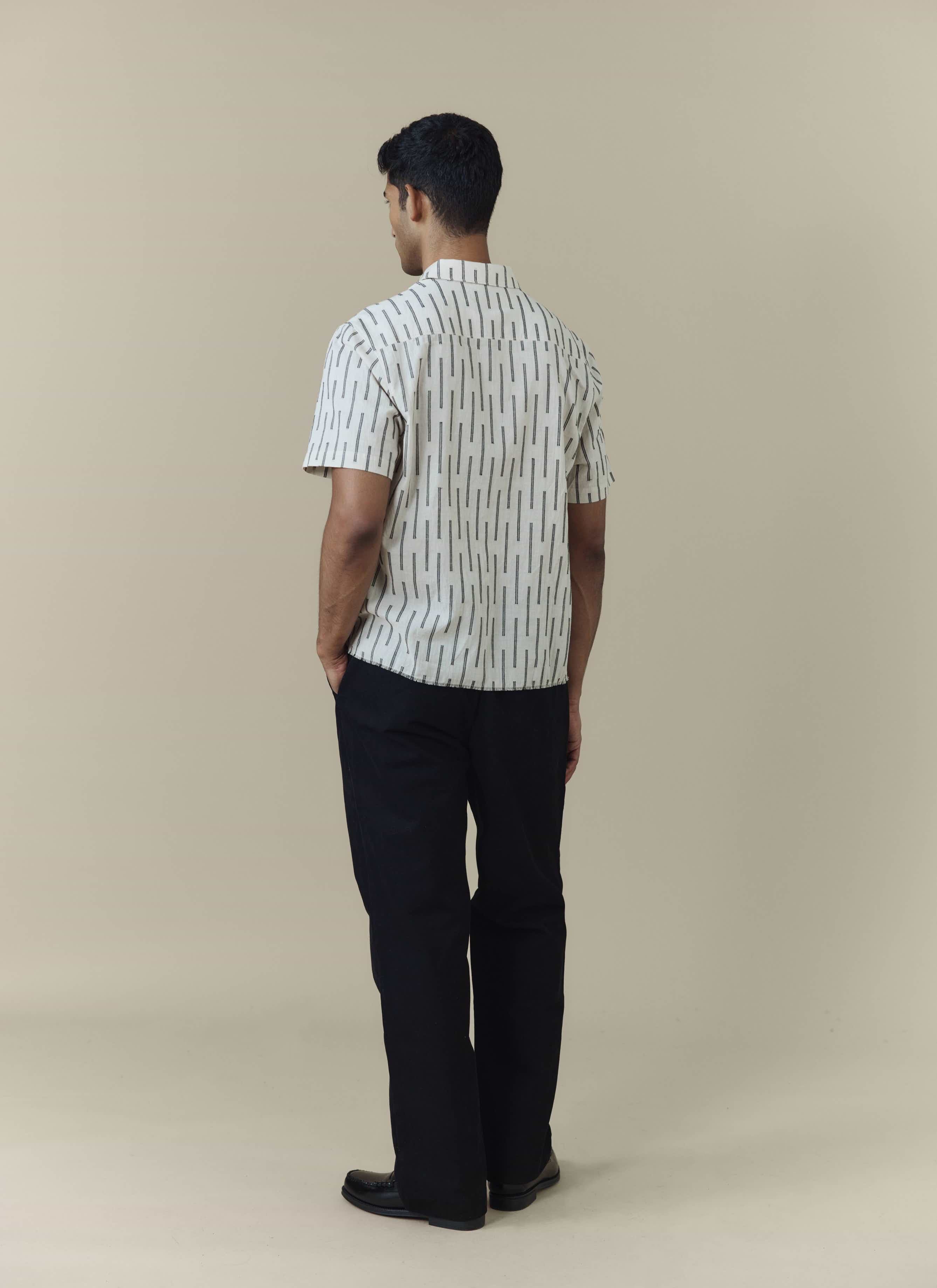 Percival Nancy Boxy Shirt in ecru cotton with black vertical stripes, shown from the back on a model.