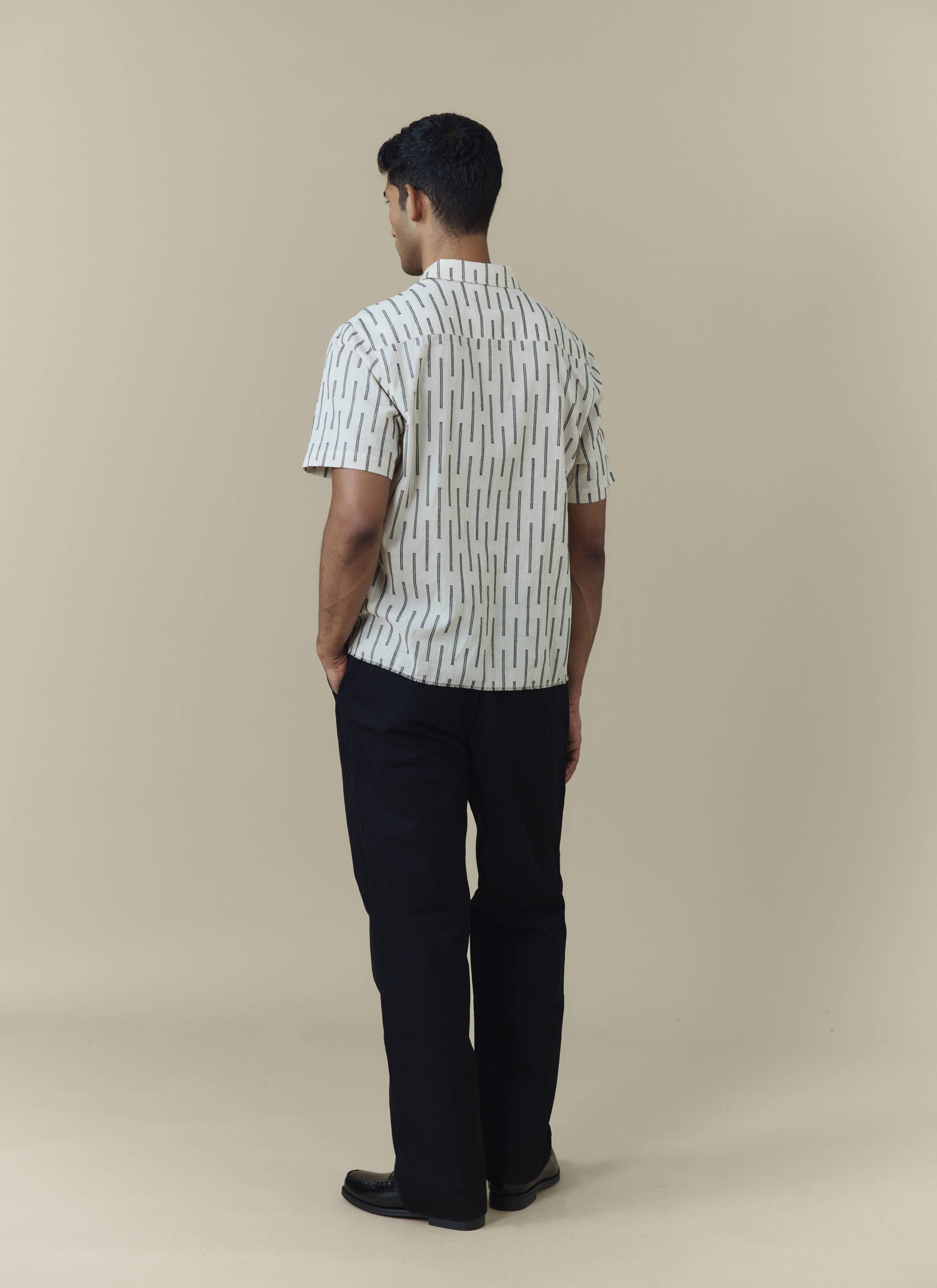 Percival Nancy Boxy Shirt in ecru cotton with black vertical stripes, shown from the back on a model.