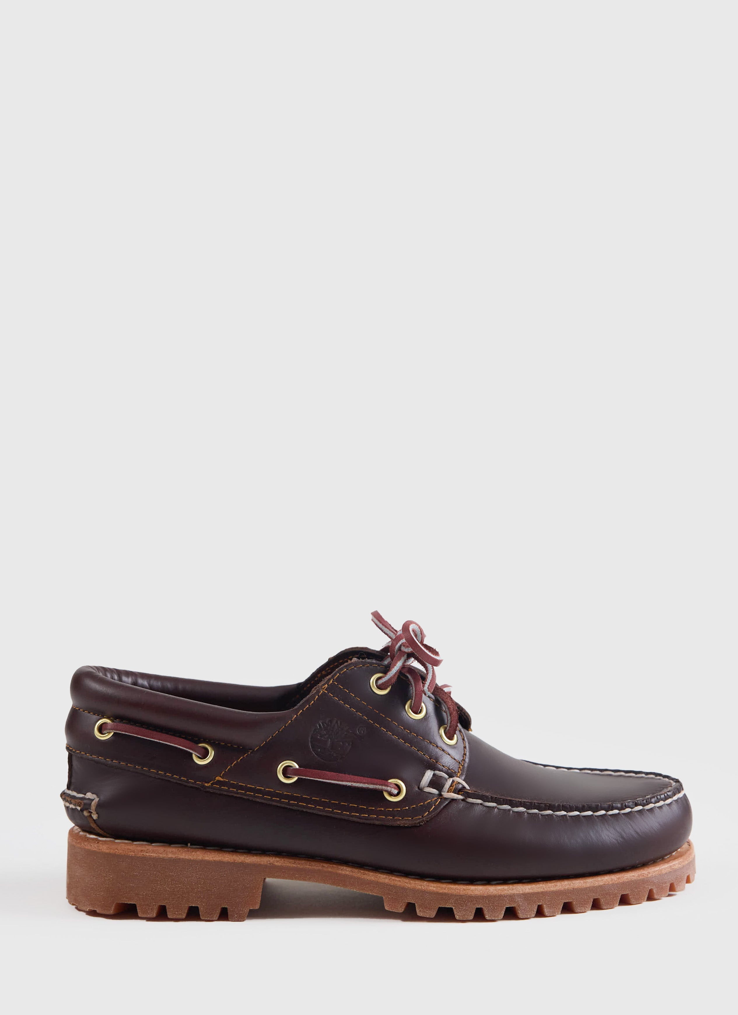 Side profile of the Timberland Authentic Boat Shoe in brown at Percival, featuring a rugged lug sole and rawhide laces.