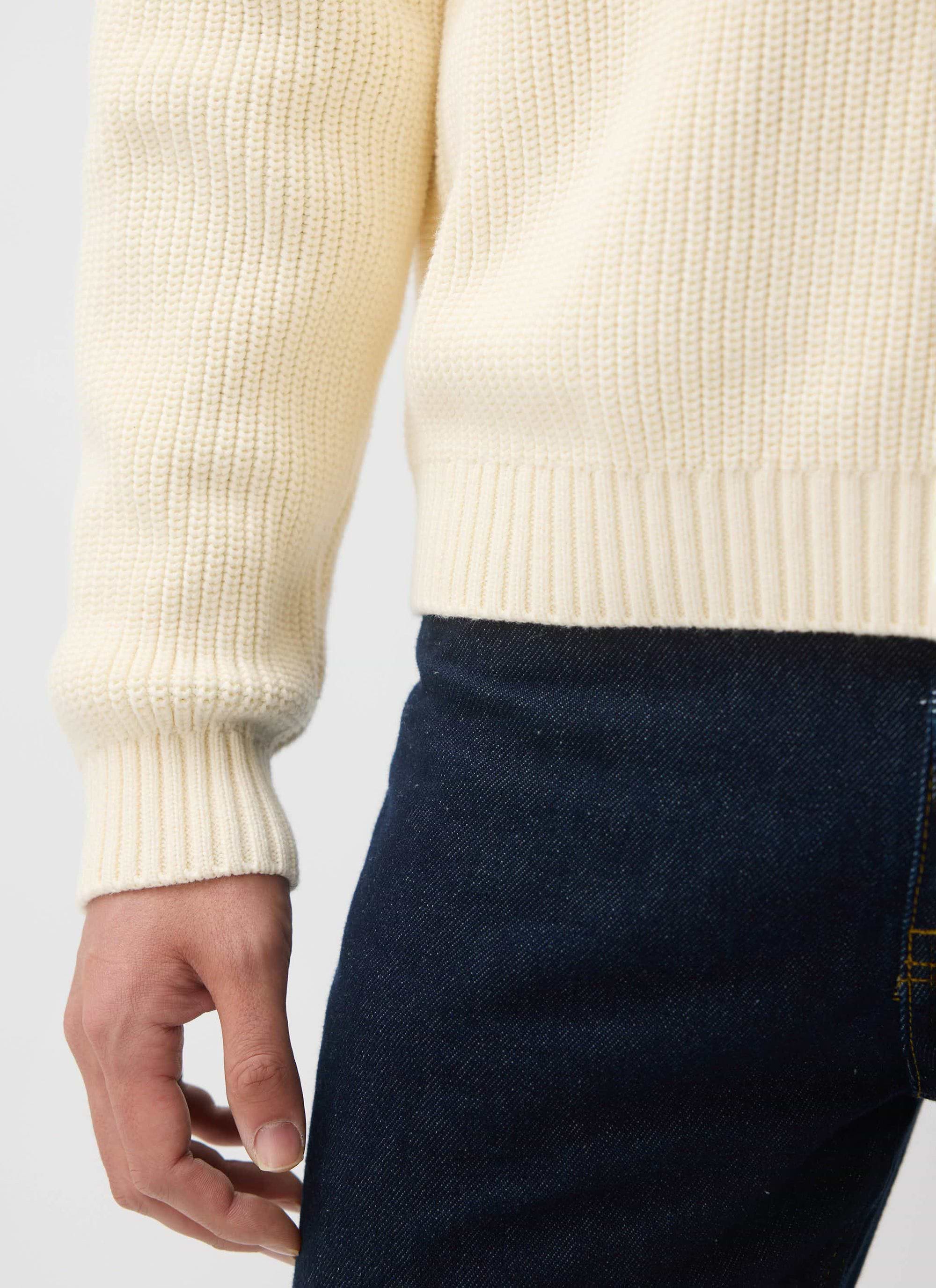 Close-up of the Percival Meyer Quarter Zip in ecru cotton, highlighting the chunky ribbed detail on the cuff and hem.