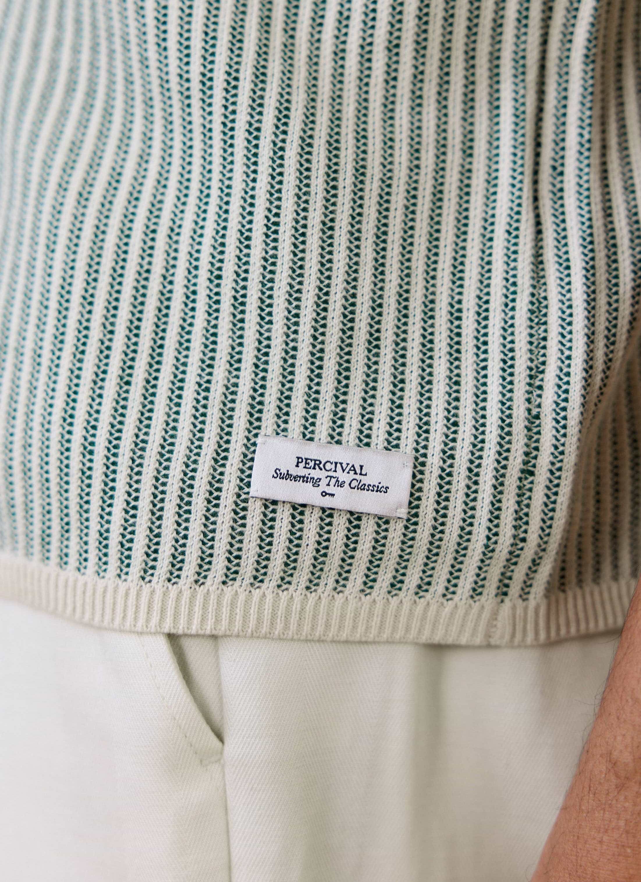 Close-up of the Percival brand label on the Dixon Knitted Shirt in cream, highlighting the vertical stitch knit texture.