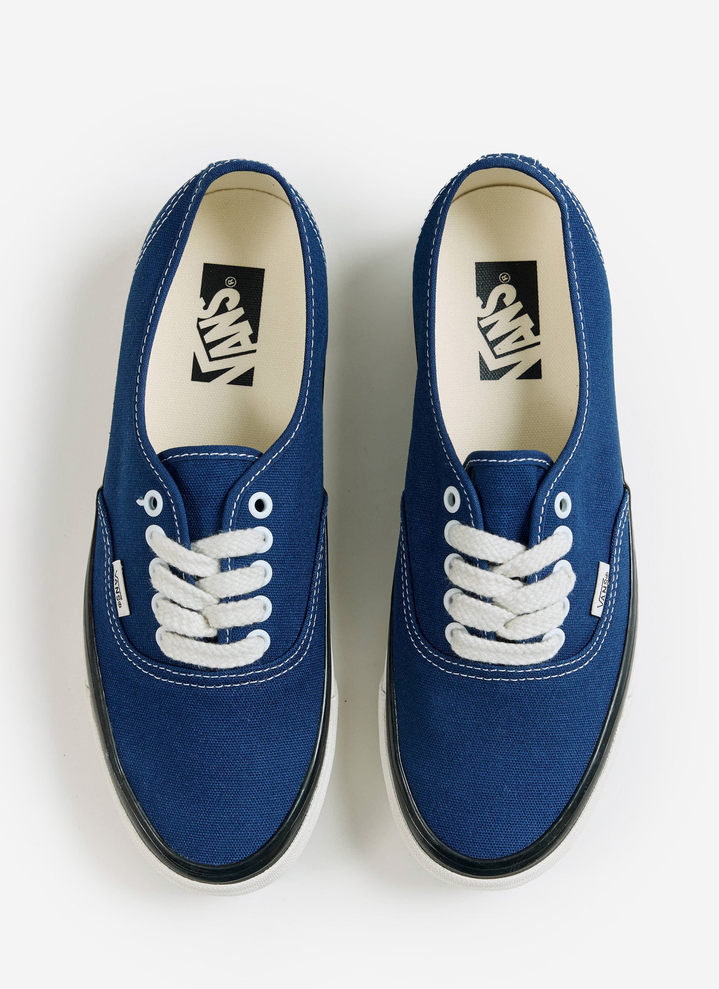 A top-down view of the blue Vans Premium Authentic 44 shoes with white laces, available at Percival.