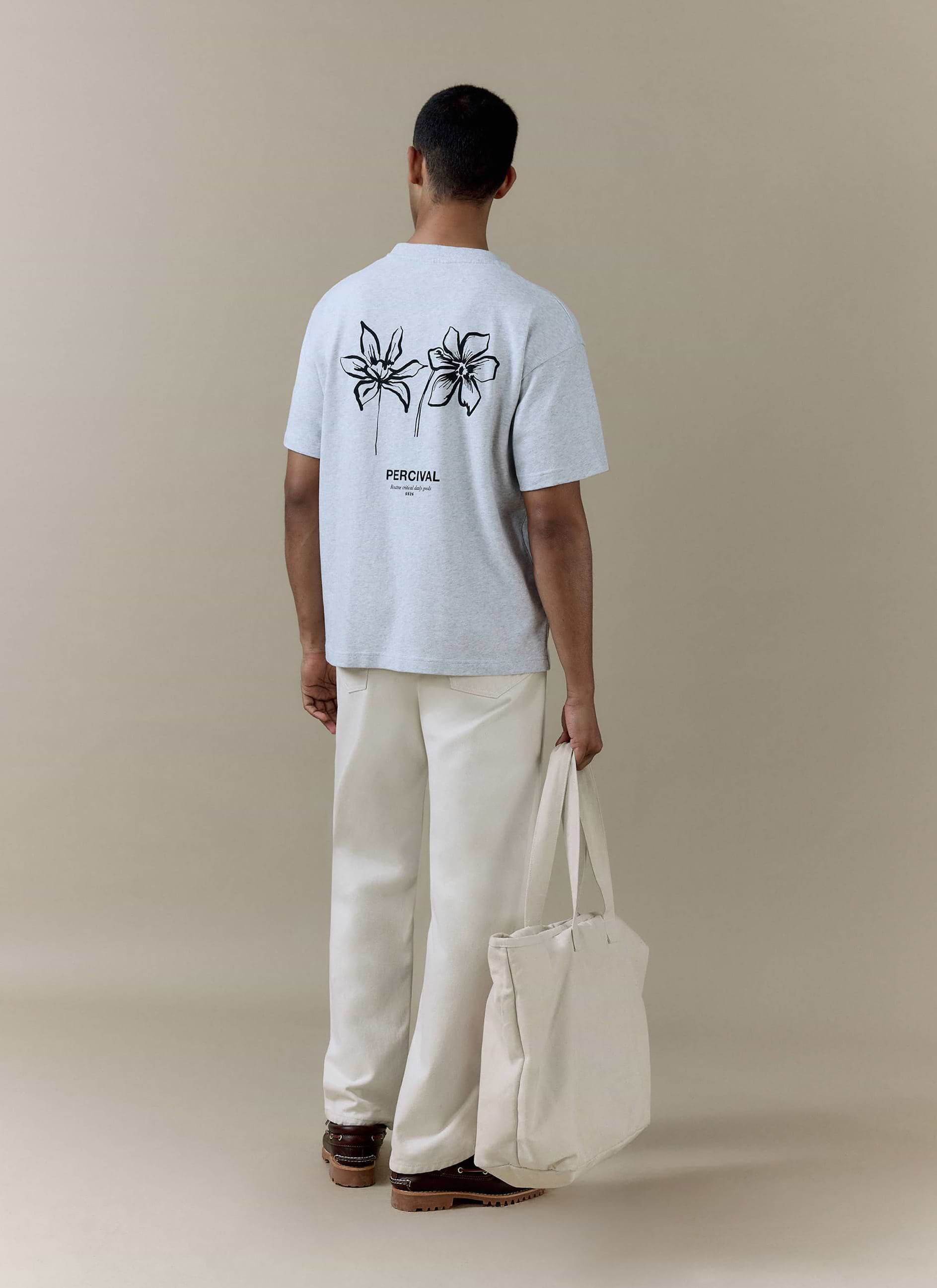 Percival Melvin Oversized T-Shirt in grey organic cotton, featuring a black floral graphic and branding on the back.