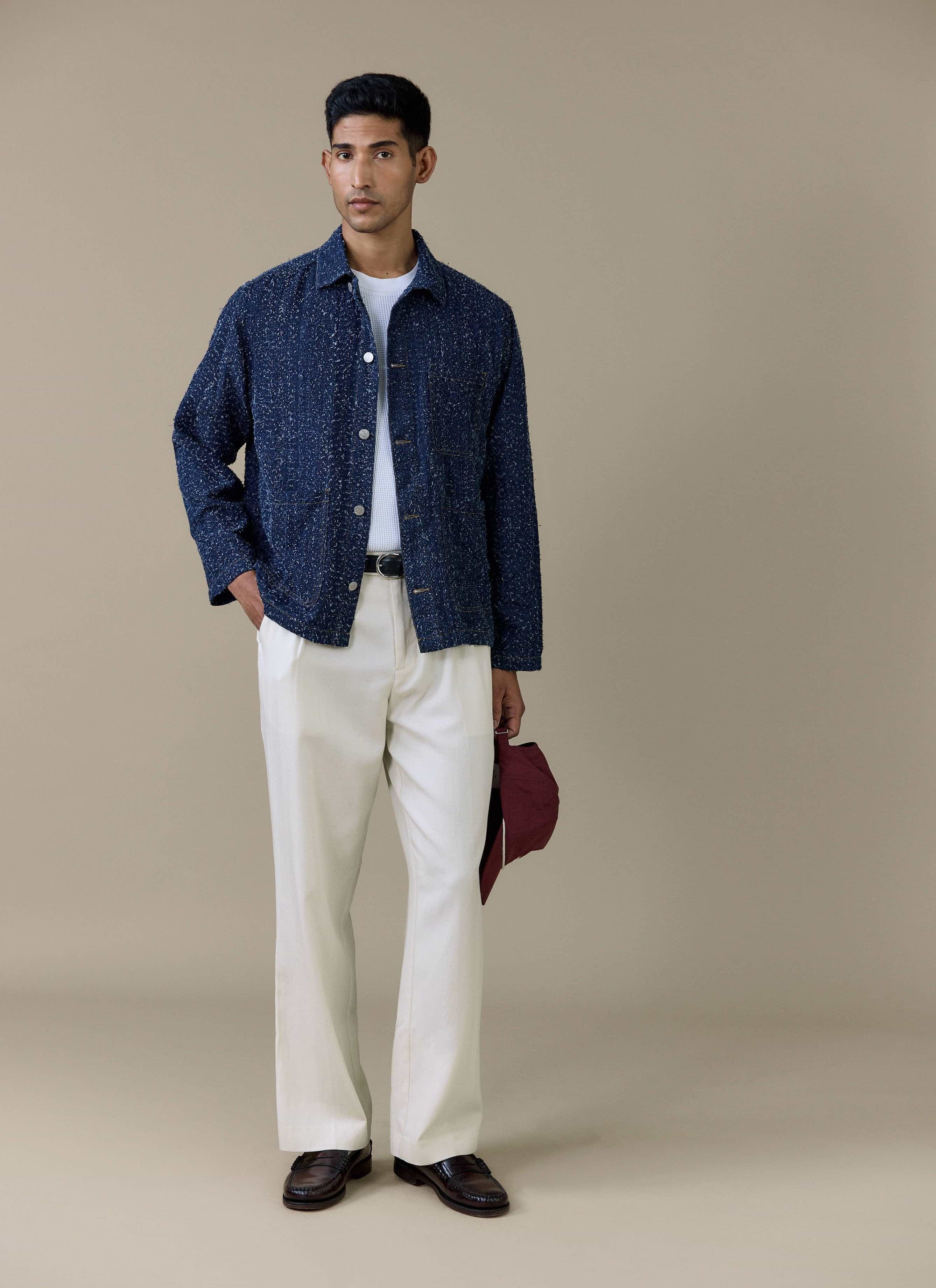 Full-length shot of a model wearing the Percival Parsons Chore Jacket in navy cotton with contrast stitching.