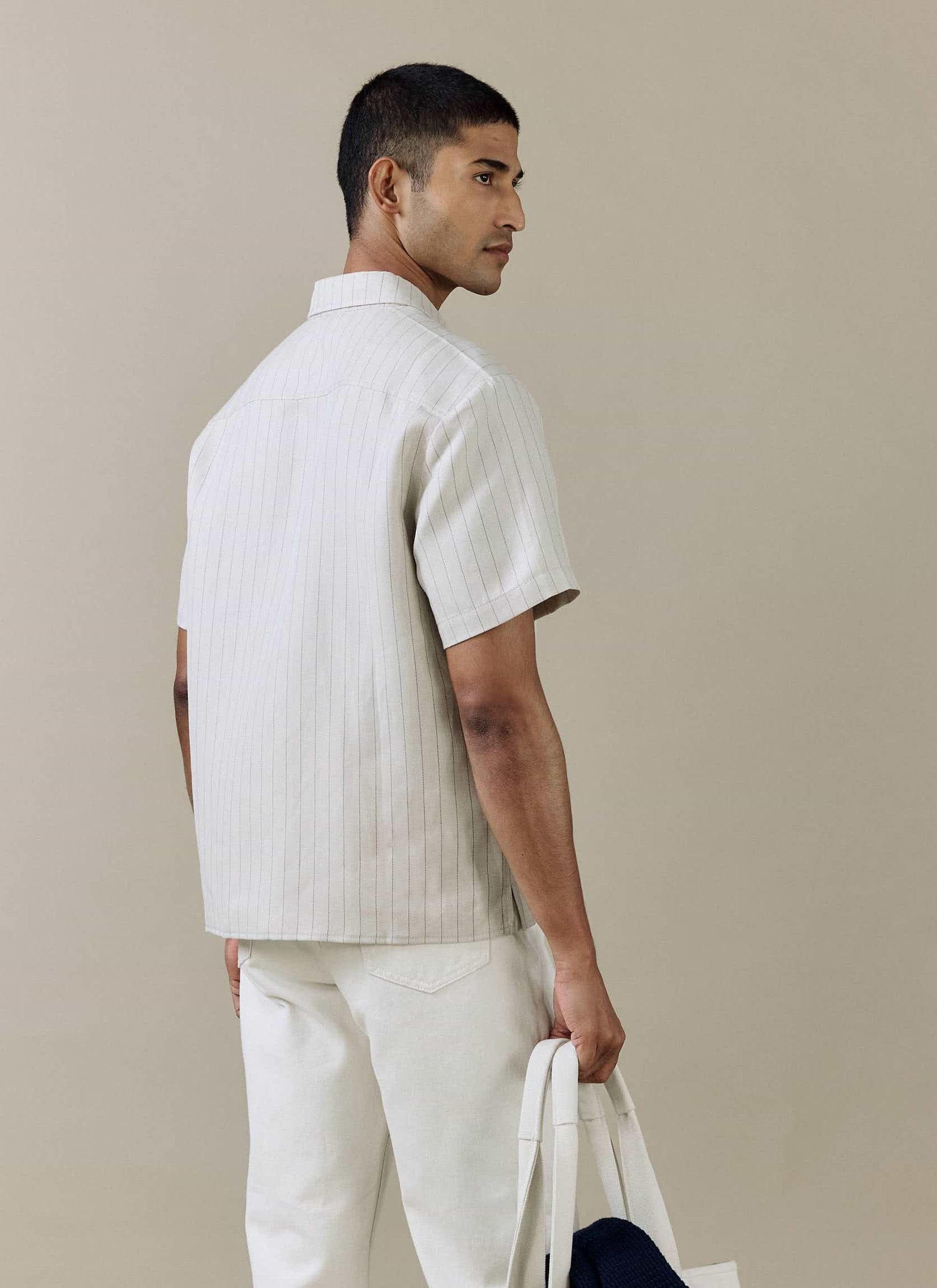 Rear view of the Percival Striped Boxy Shirt in cream linen blend, showing the pinstripe detail on a model.