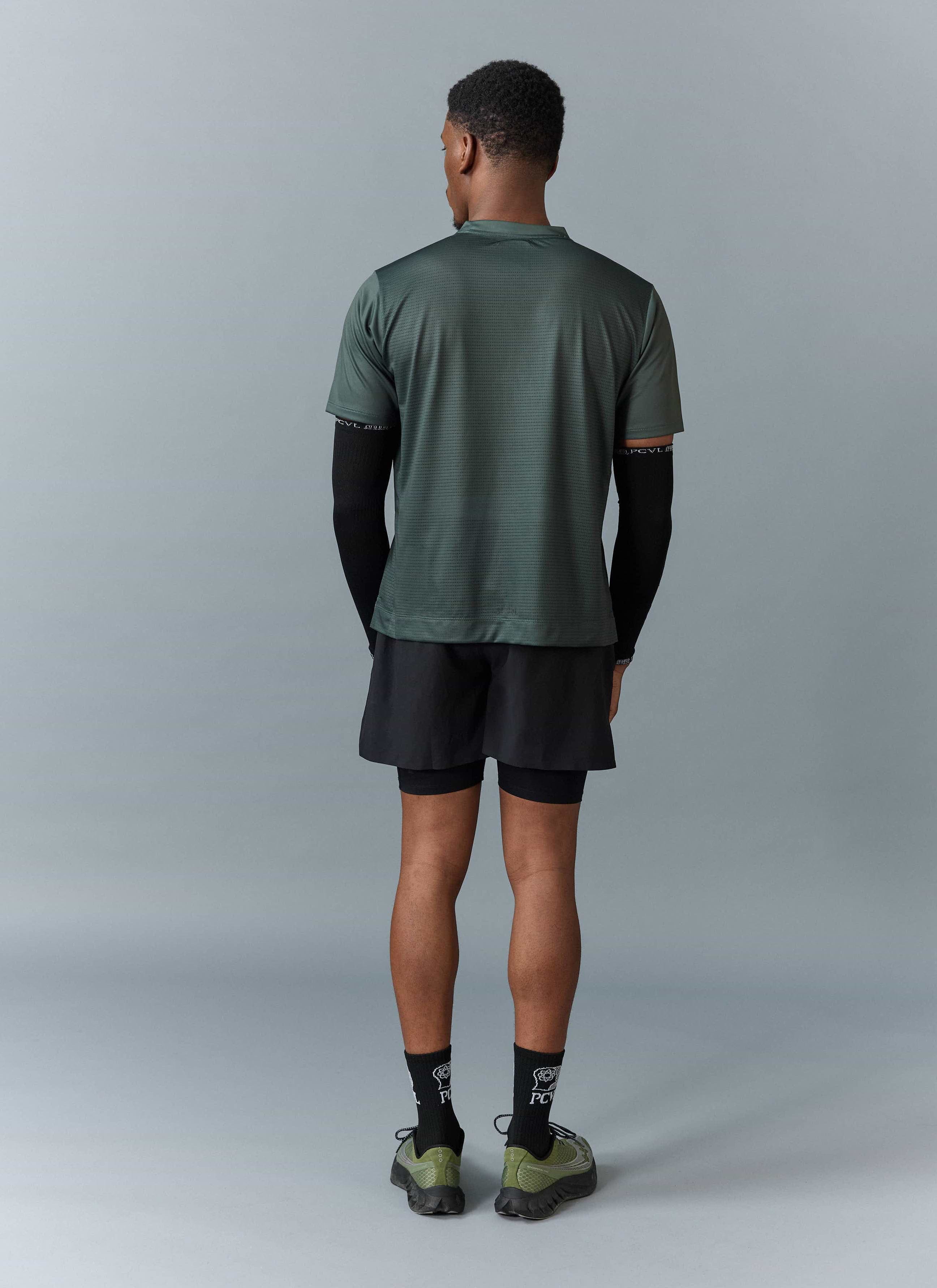 Back view of a model wearing the Percival PCVL Printed Performance Top in forest green, showing the lightweight material.