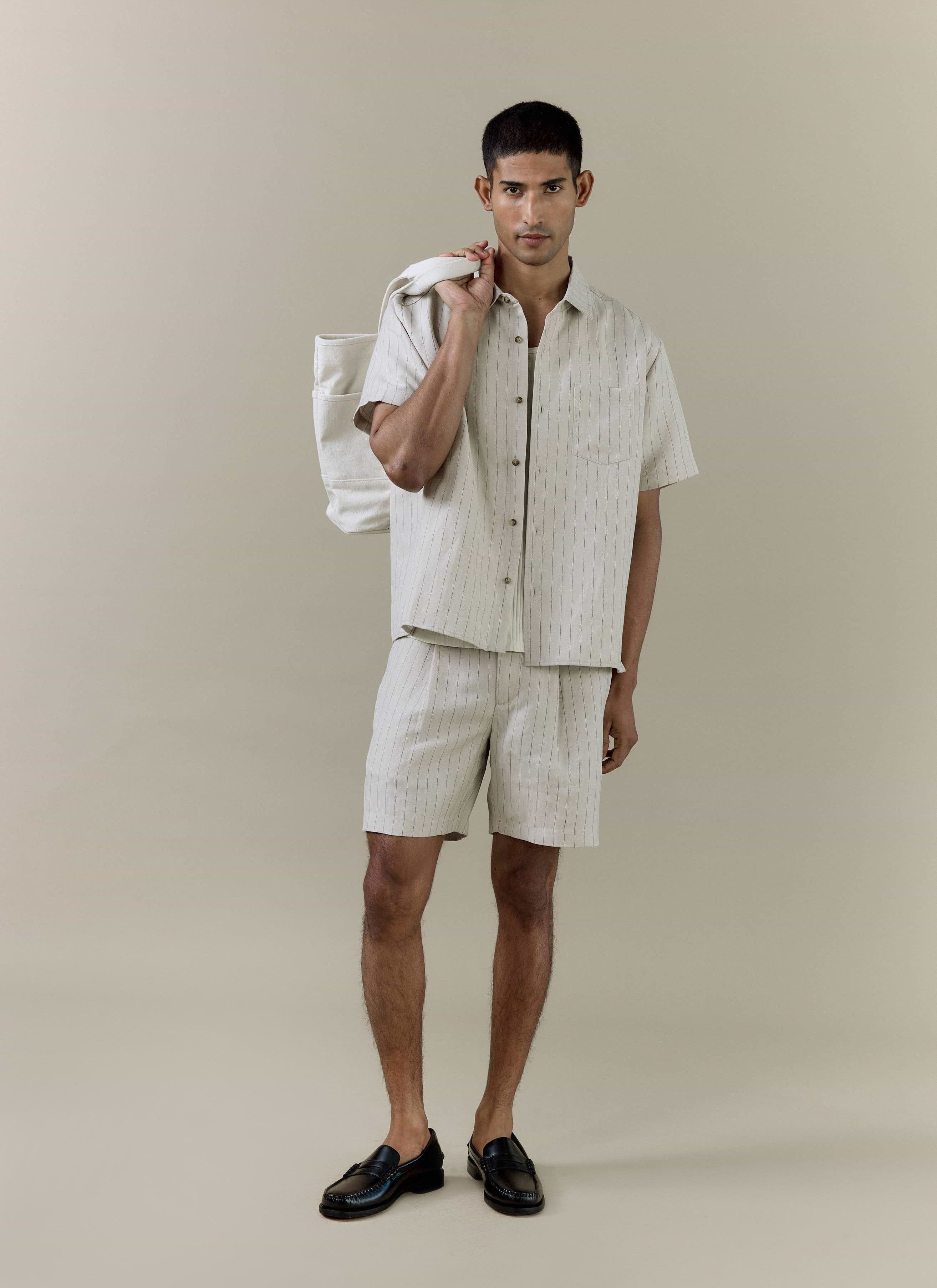 Percival cream striped tailored shorts in a linen blend, worn by a model with a matching short-sleeved shirt.