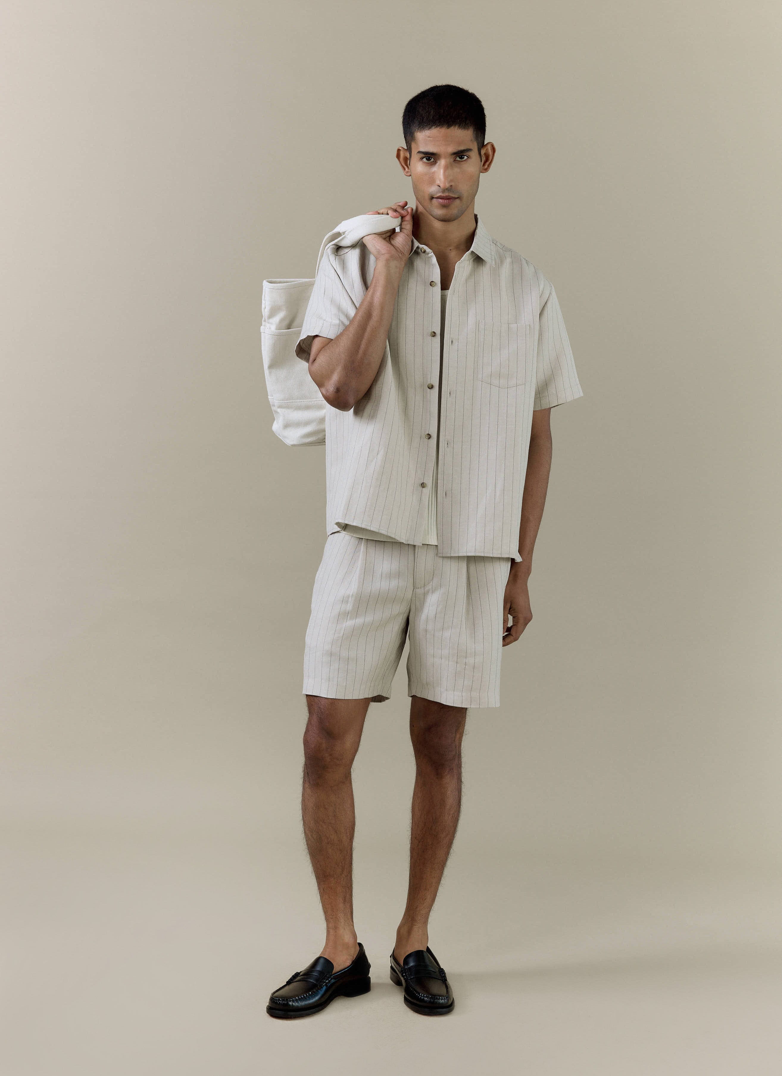 Percival cream striped tailored shorts in a linen blend, worn by a model with a matching short-sleeved shirt.