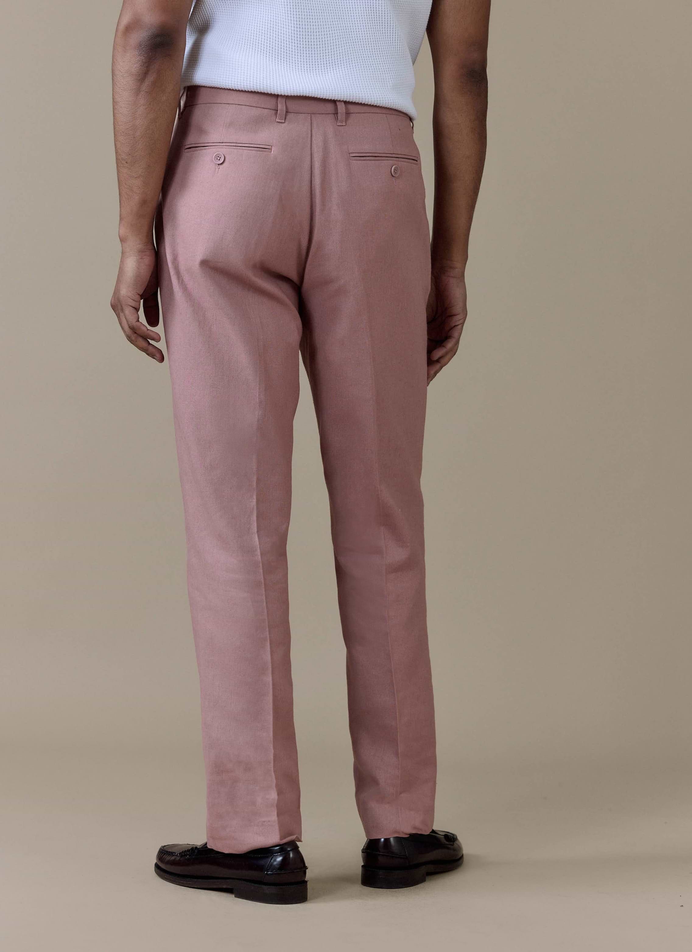 Dusty pink Percival Tailored Linen Trousers shown from behind, featuring buttoned welt pockets and a sharp centre crease.