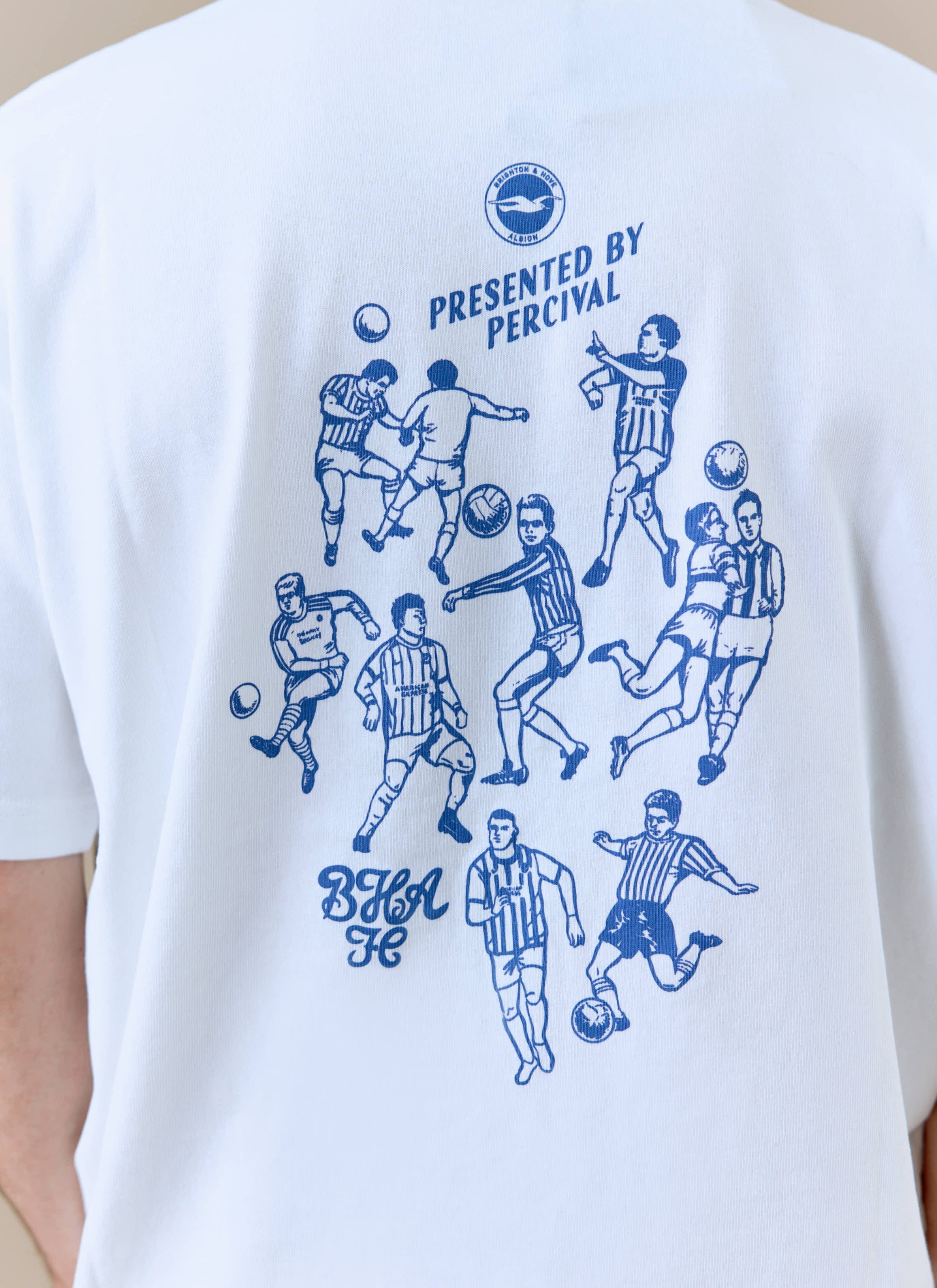 Close up of the back of the white Percival x Brighton & Hove Albion F.C. t-shirt, showing the blue archive kits graphic.