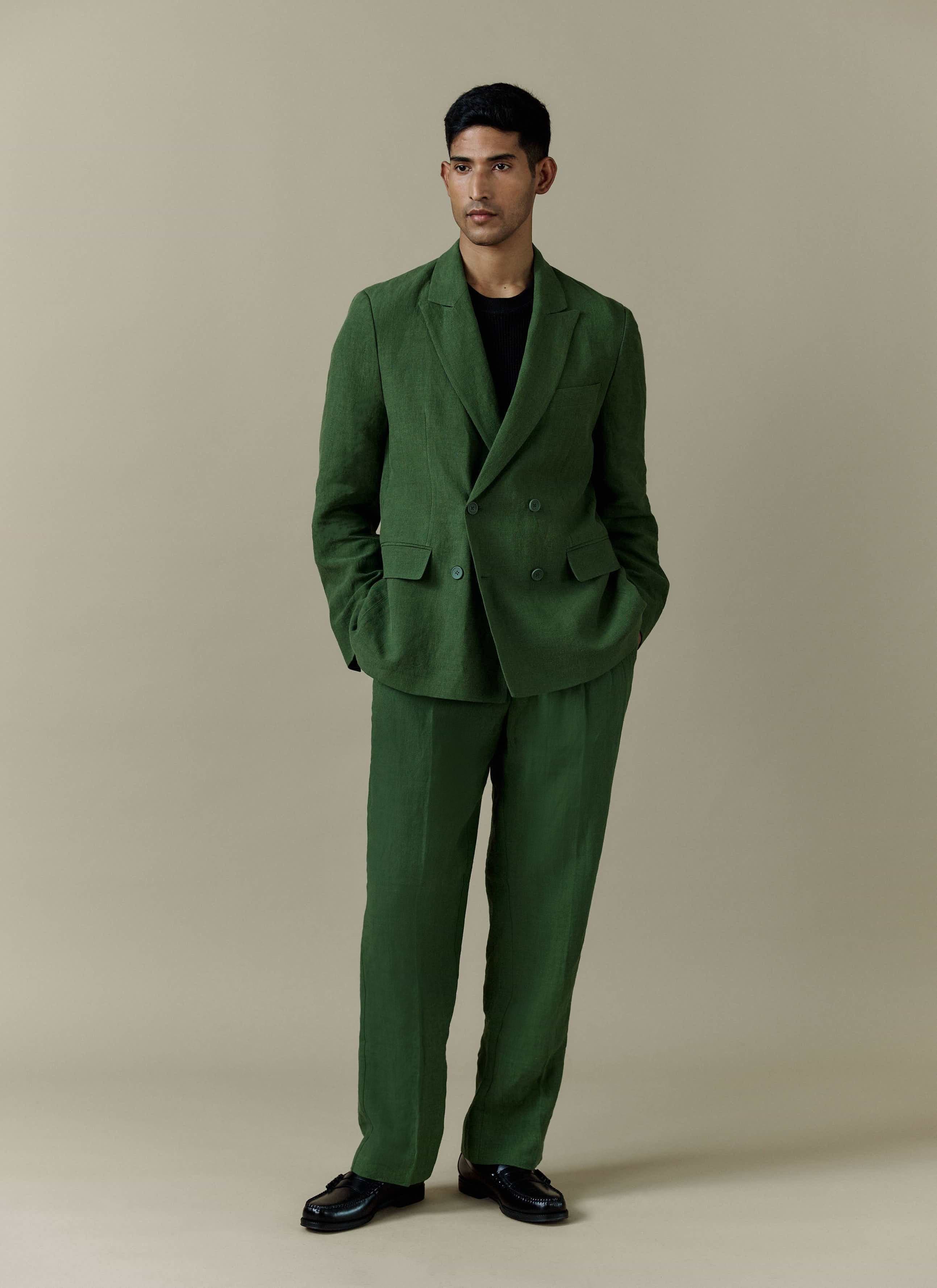 Percival forest green linen suit featuring pleated tailored trousers and a matching double-breasted blazer.