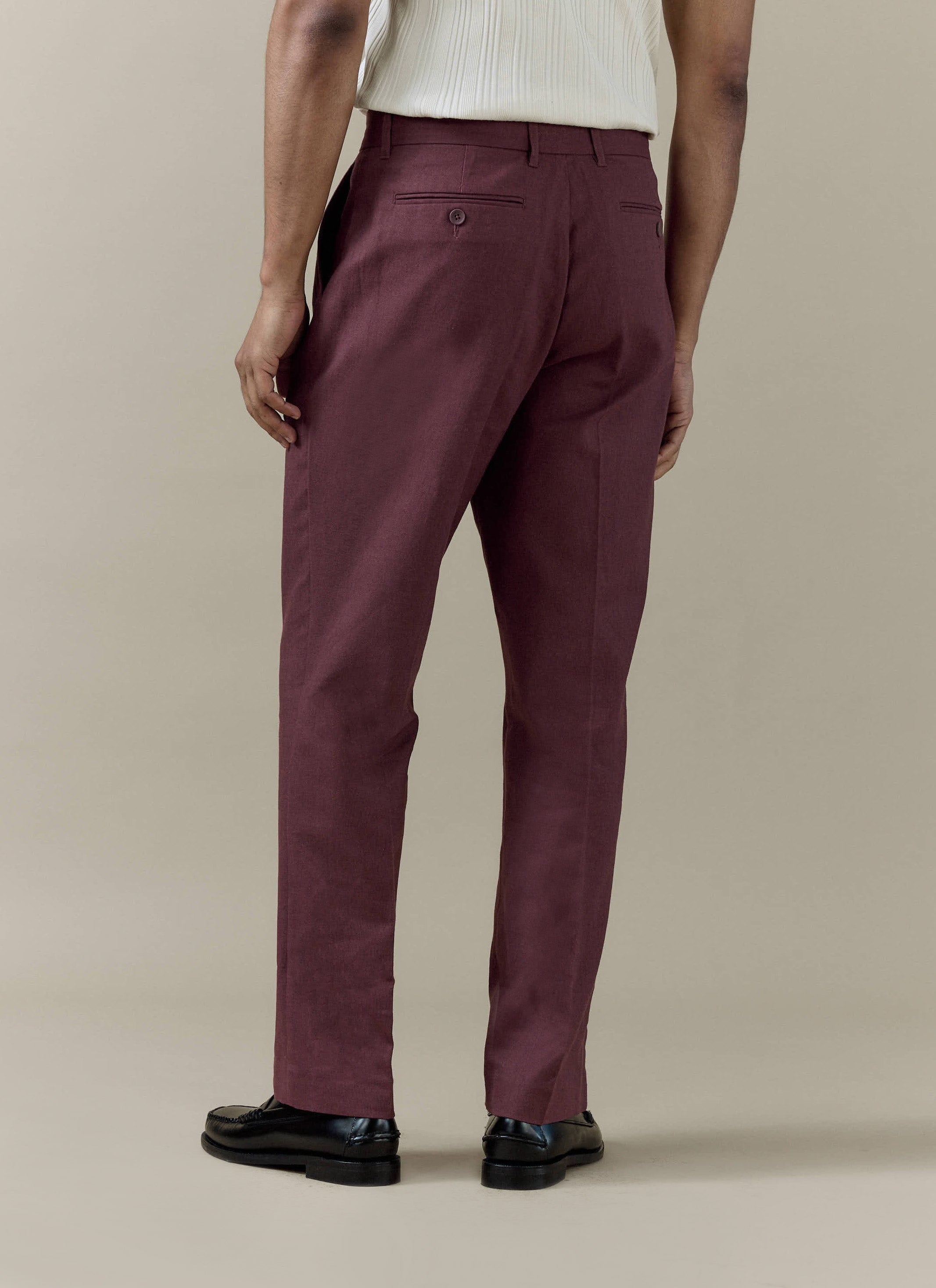 Merlot Percival tailored linen-cotton trousers seen from the back, showing the straight leg and pressed crease.