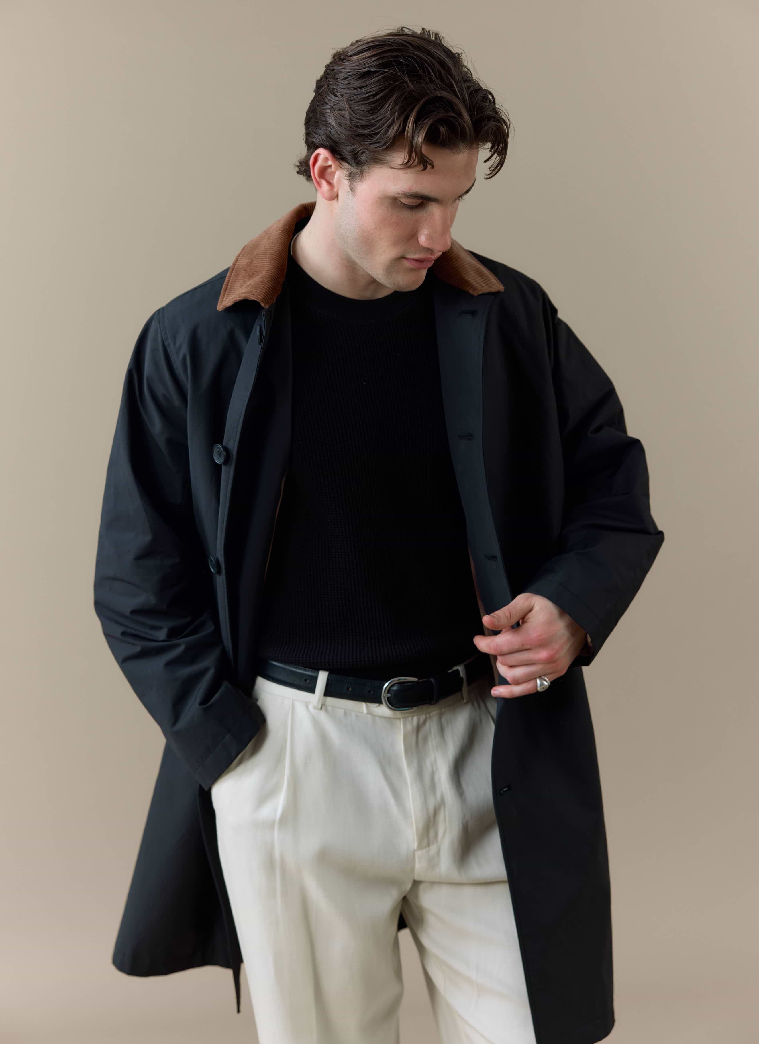 Model wears the black Percival Cord Collar Relaxed Trench Coat, featuring a contrast brown corduroy collar.