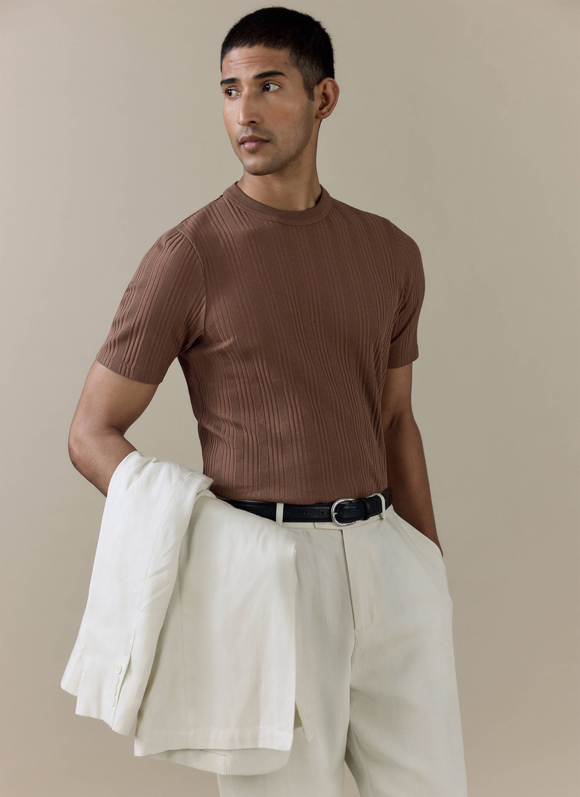 Brown Leon Ribbed T Shirt in cotton by Percival, styled on a model with white trousers and a jacket.