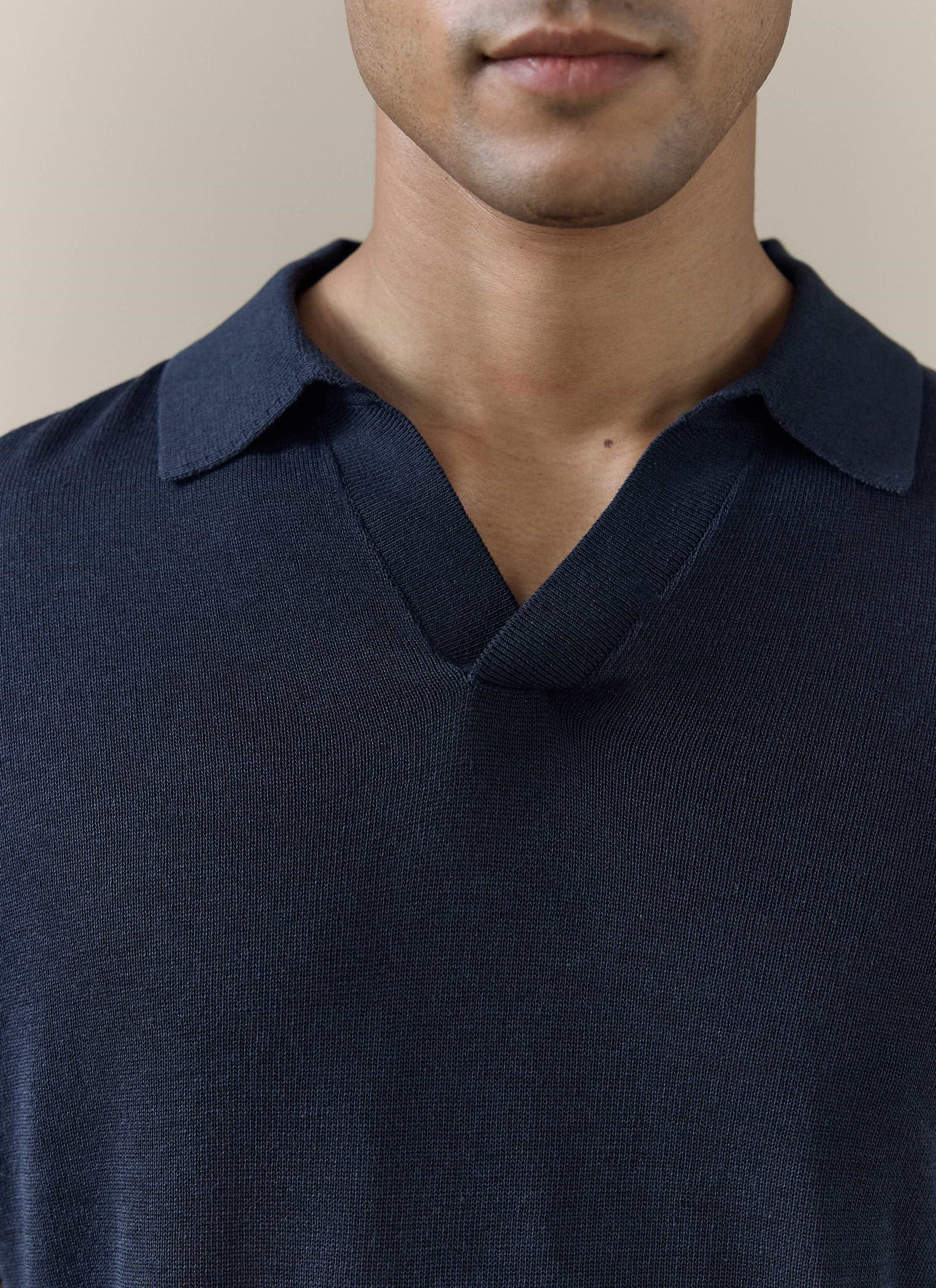 Close-up of the navy Percival Laurence Knitted Polo, showing the refined V placket and breathable linen lyocell blend.