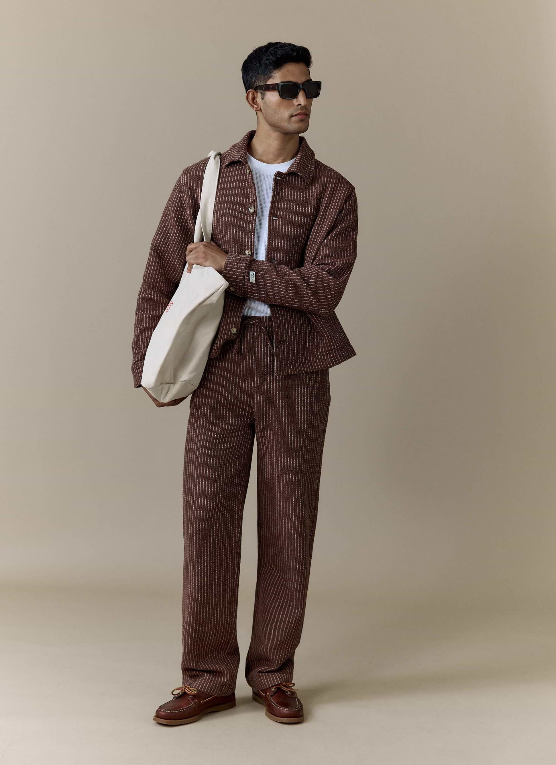 Brown pinstriped Percival Sorrento wide leg trousers in a linen blend, worn by a model as part of a matching co-ord.