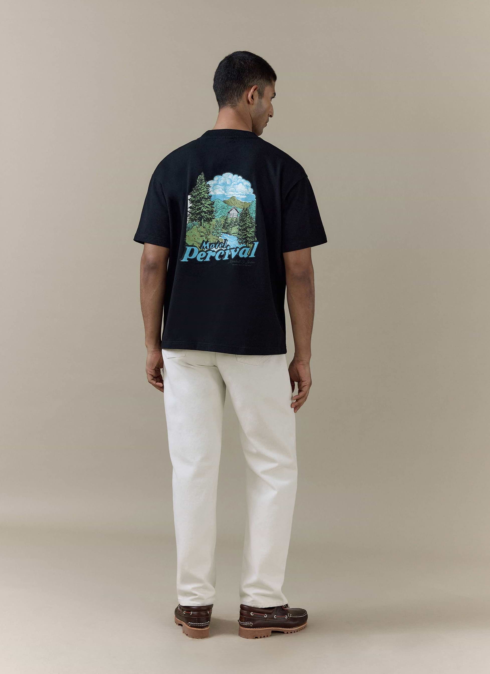 Rear view of the black organic cotton Percival Arnold Oversized T Shirt with colourful Motel Percival scenic graphic.