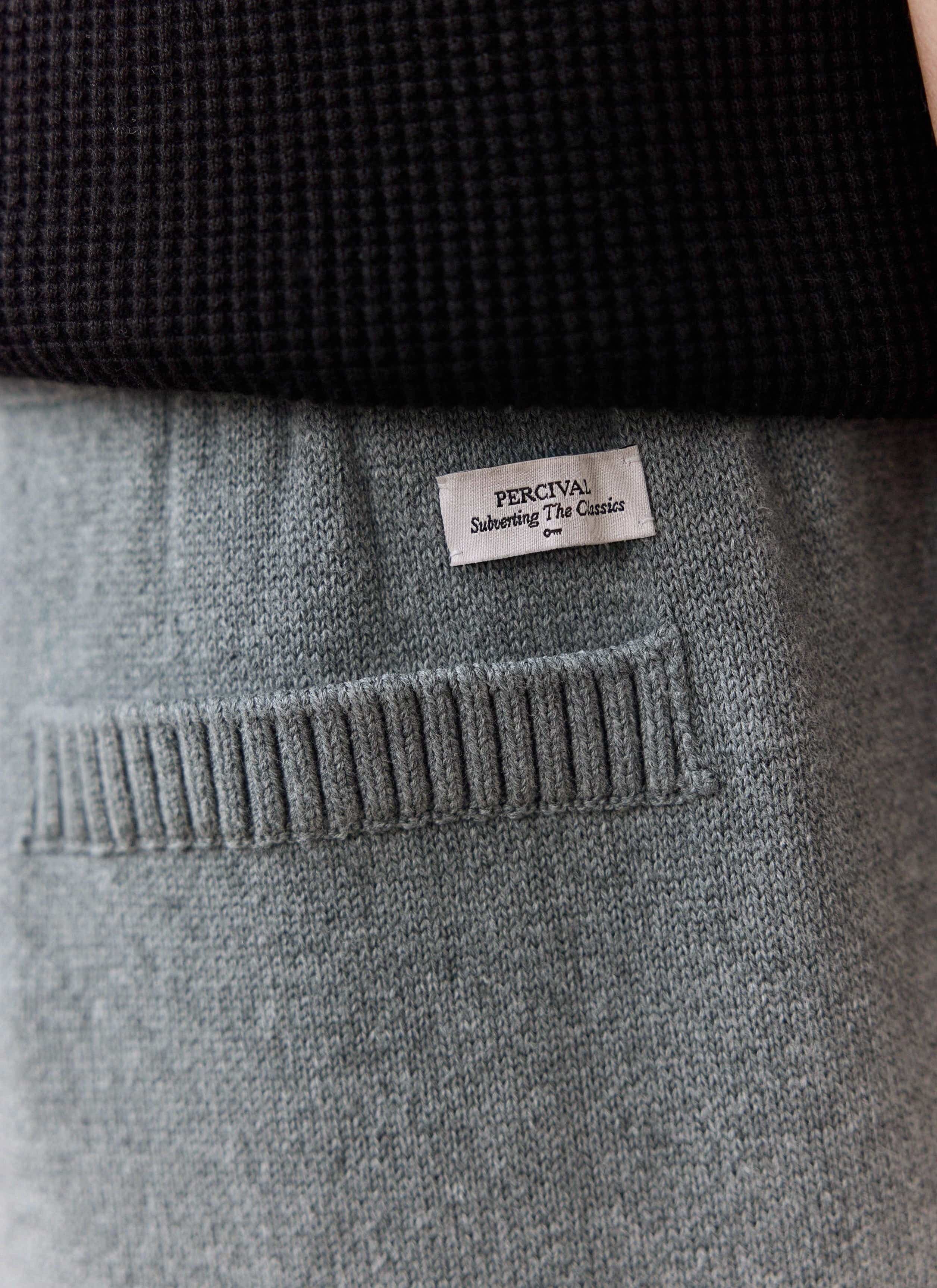 A close-up of the back pocket on the grey Chronicle Knitted Trackpant, showing the woven Percival label.