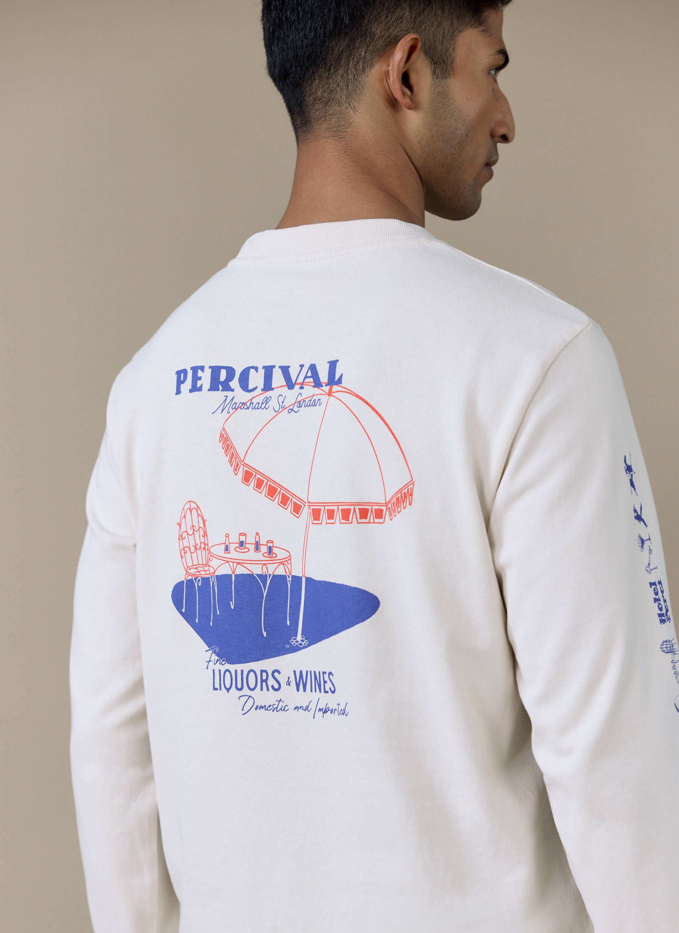 Back of the cream Percival Harlow Fine Wines long sleeve T-shirt, featuring a large blue and red bistro-style back graphic.