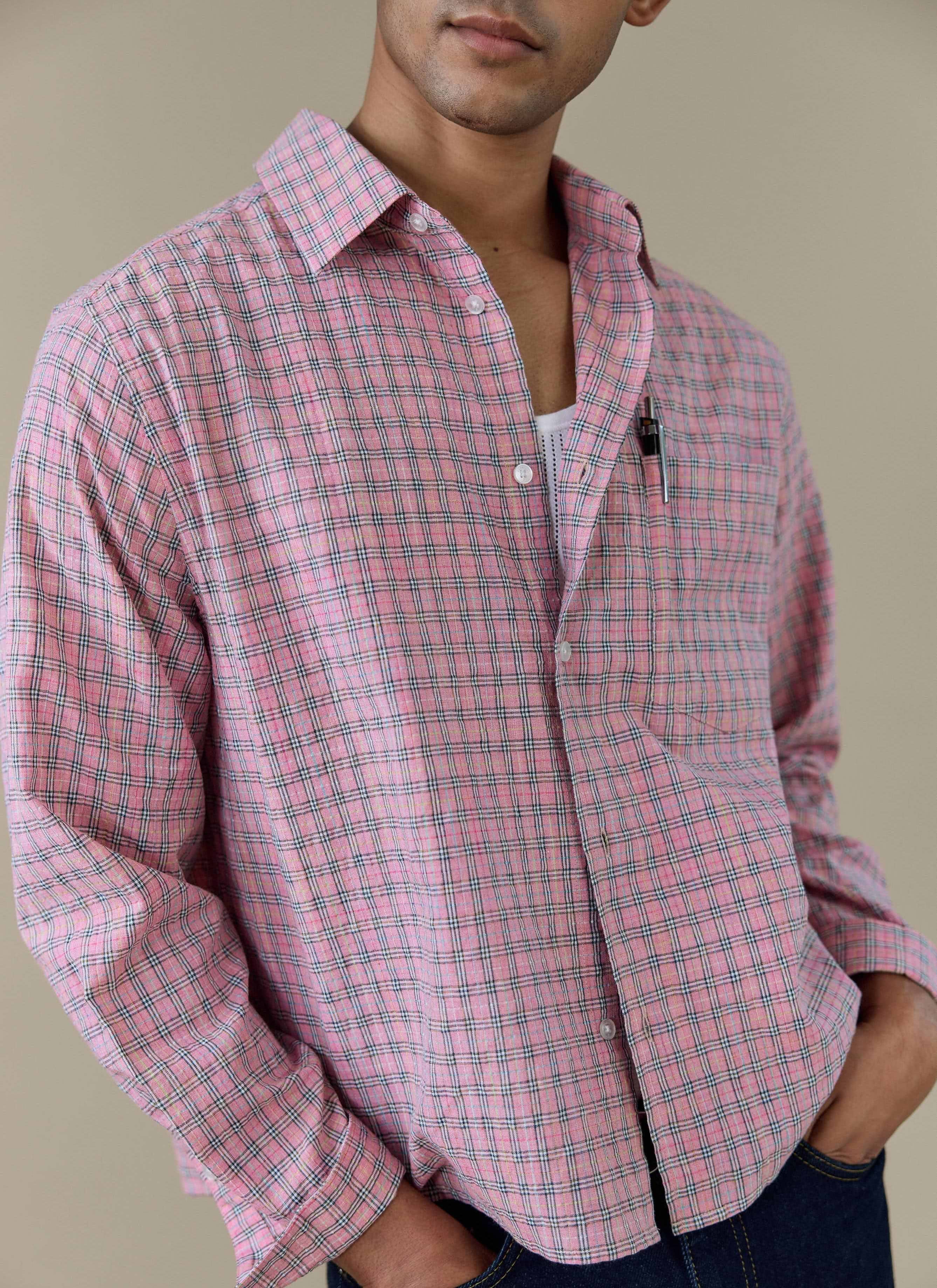 A close-up of the Percival Hinsley Checked Boxy Shirt in pink, showing the cotton check pattern and chest pocket.