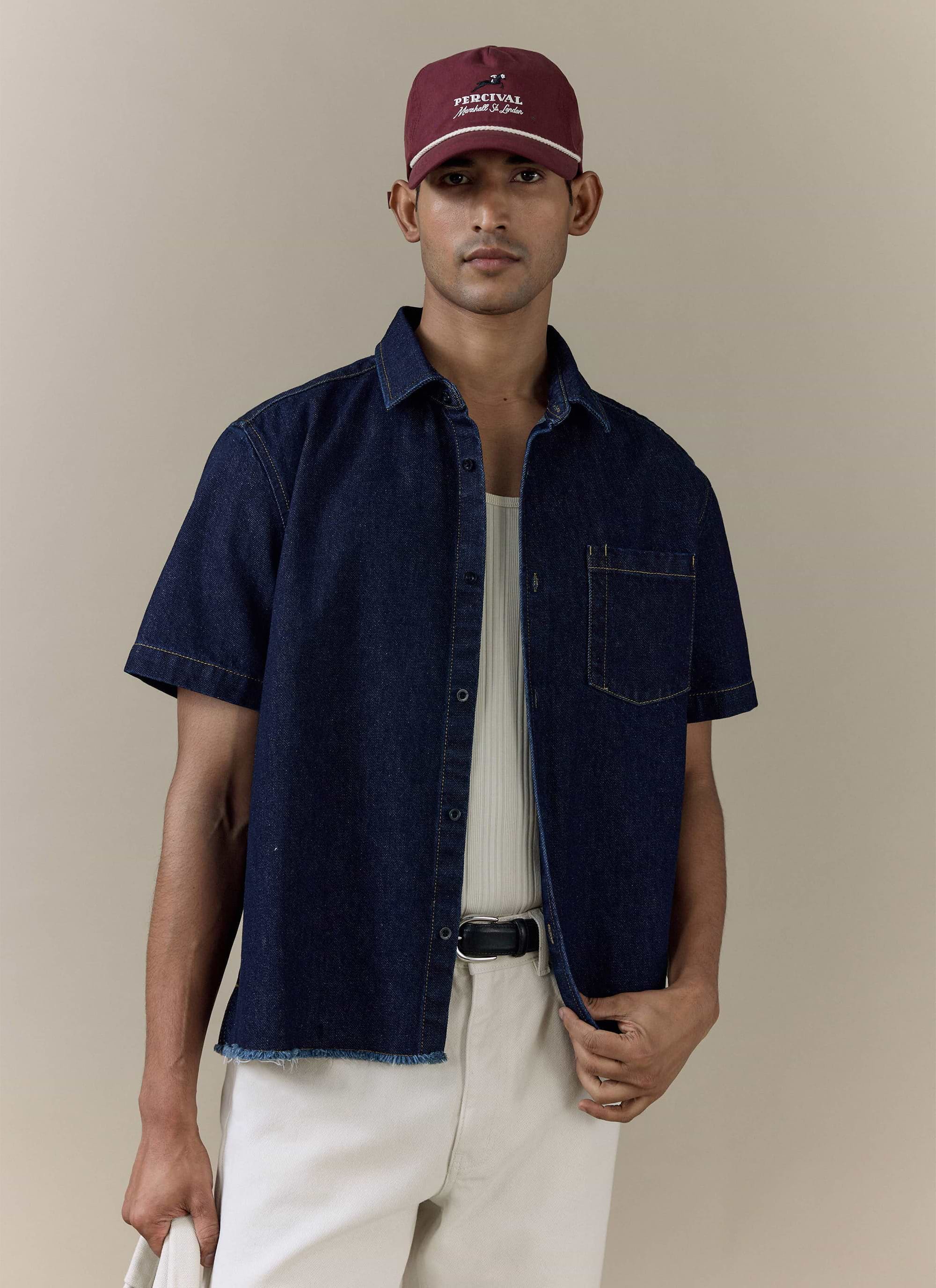 Percival Harley Denim Cropped Boxy Shirt in dark indigo cotton, featuring short sleeves and a frayed raw hem.