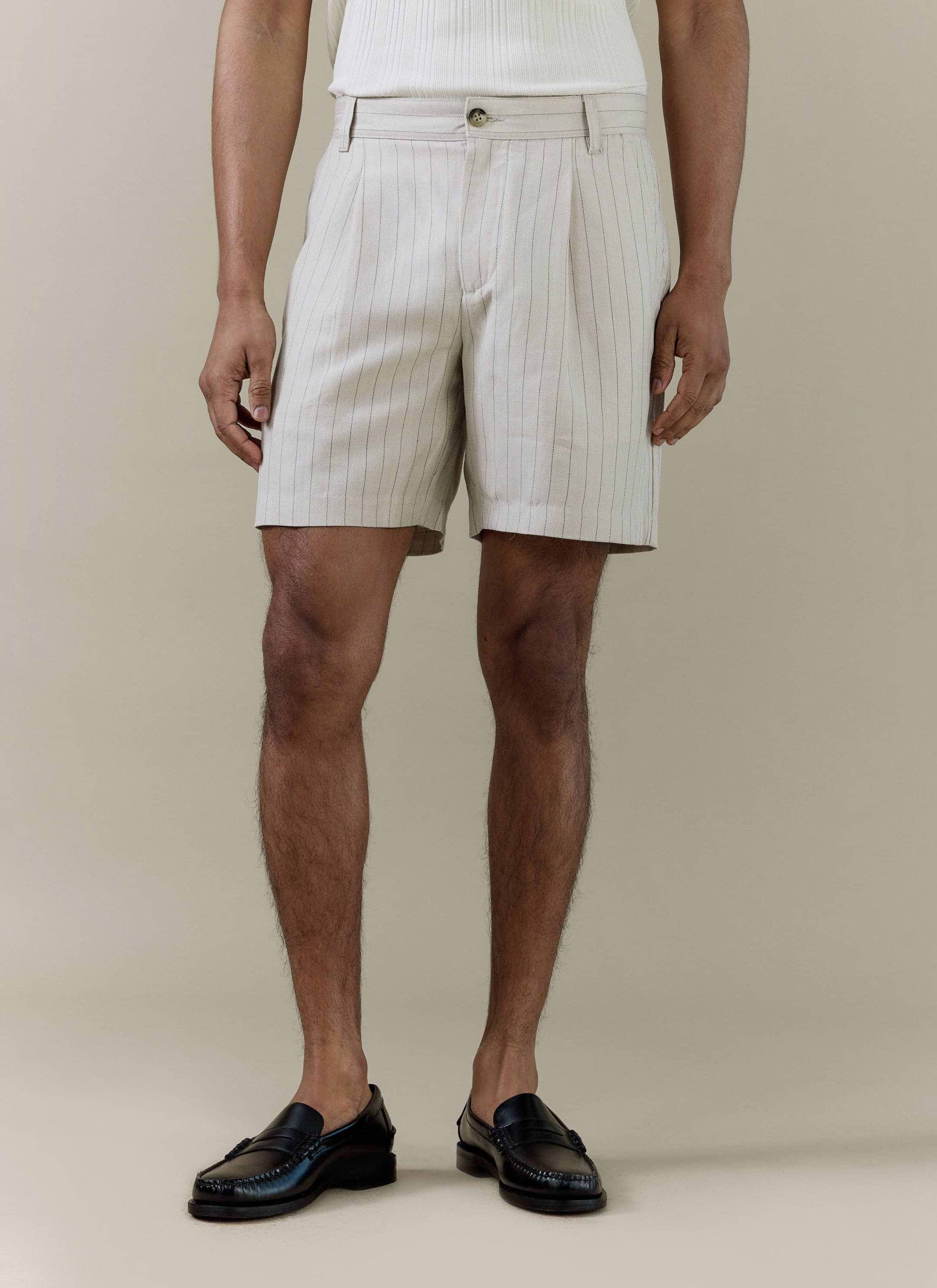 Percival Striped Tailored Shorts in a cream linen blend, featuring a pleated front and styled with black loafers.