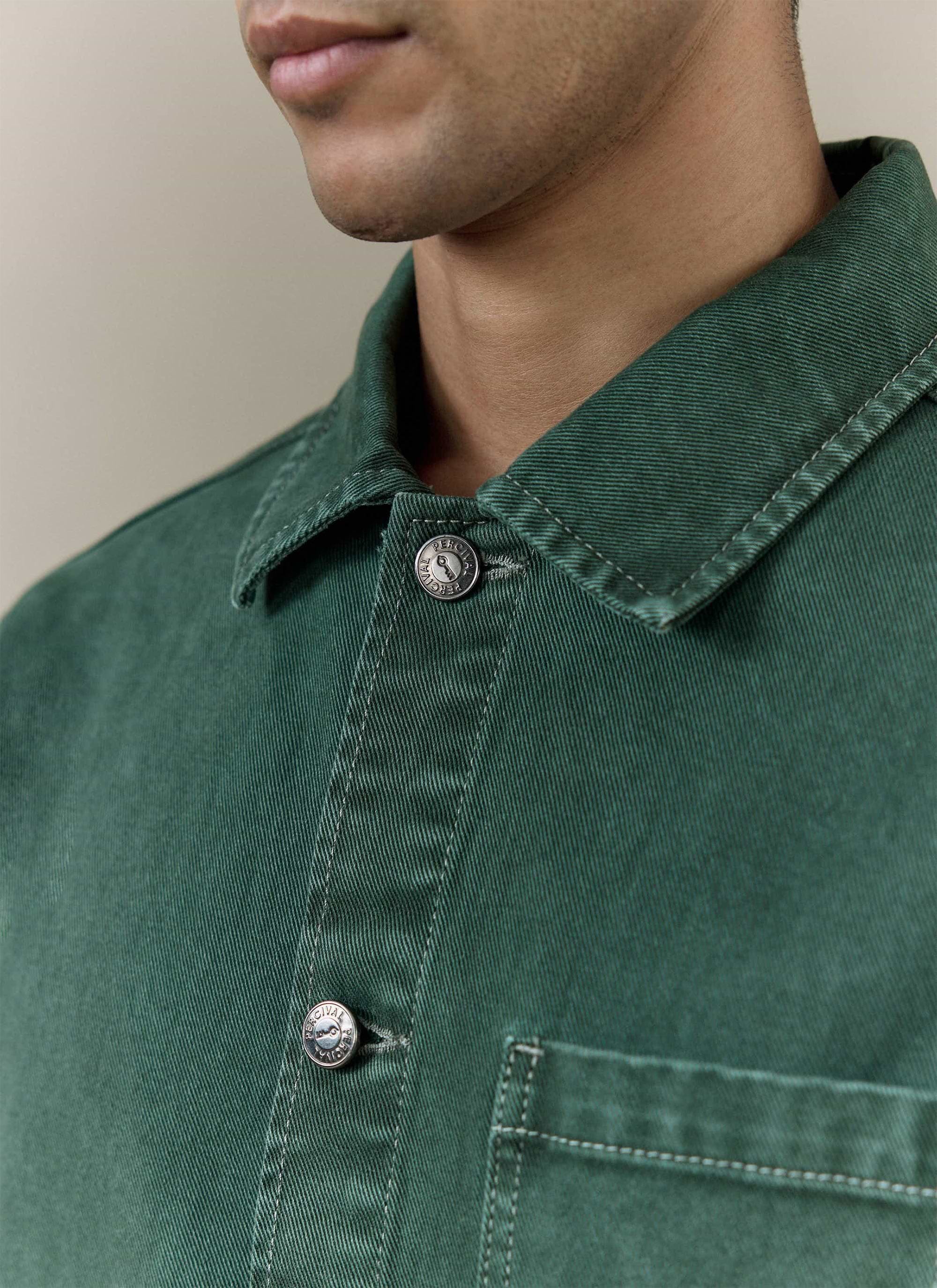 Close-up of the forest green Percival Vintage Wash Oliver Chore Jacket in cotton canvas, showing the branded metal buttons.
