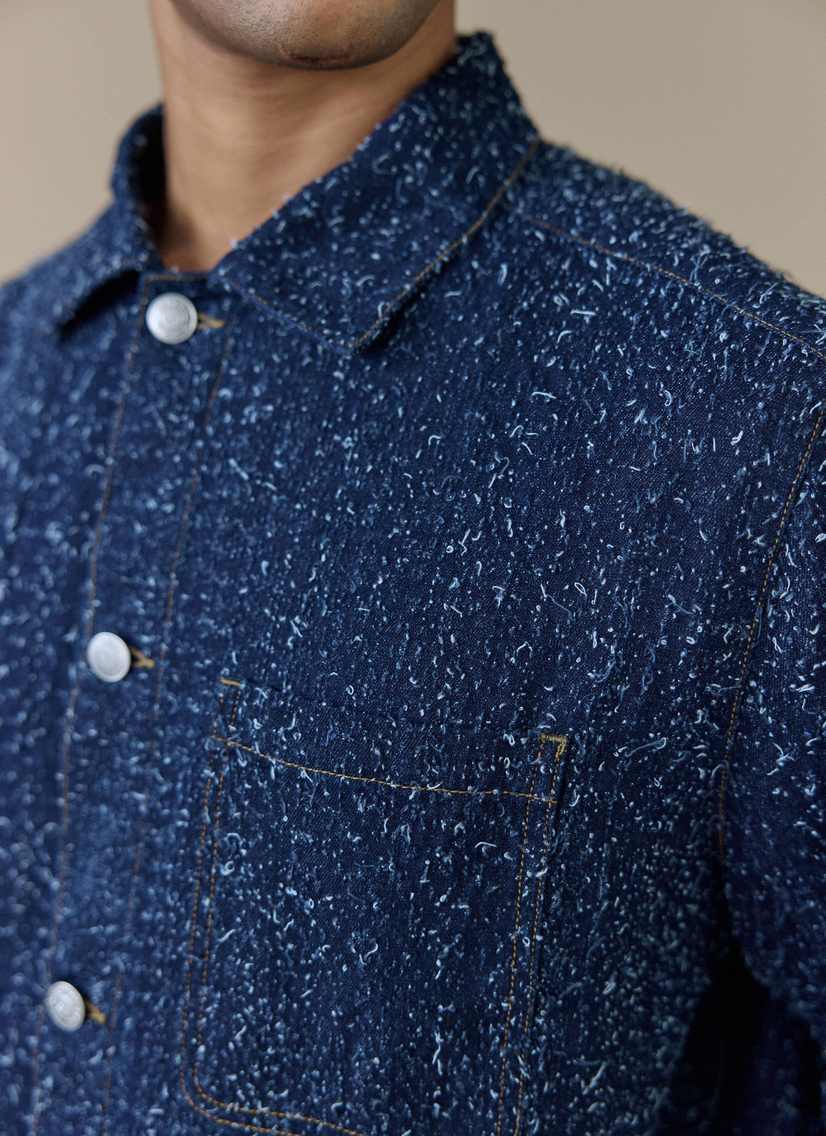 Close-up of the navy Parsons Chore Jacket by Percival, showing the textured cotton fabric and contrast stitching.