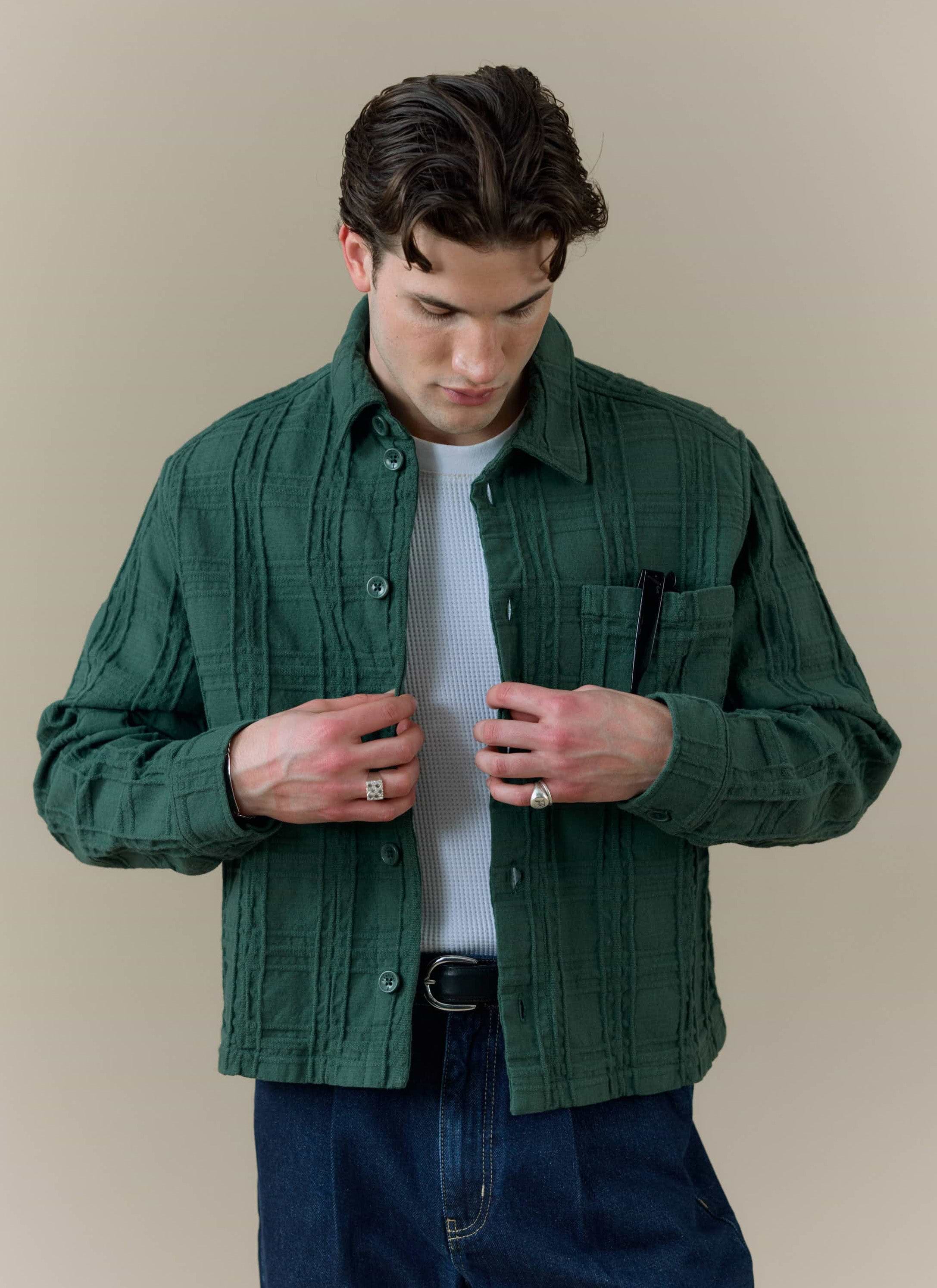 Model wearing the Percival Canyon Heavyweight Overshirt in forest green, showing the textured woven cotton fabric.