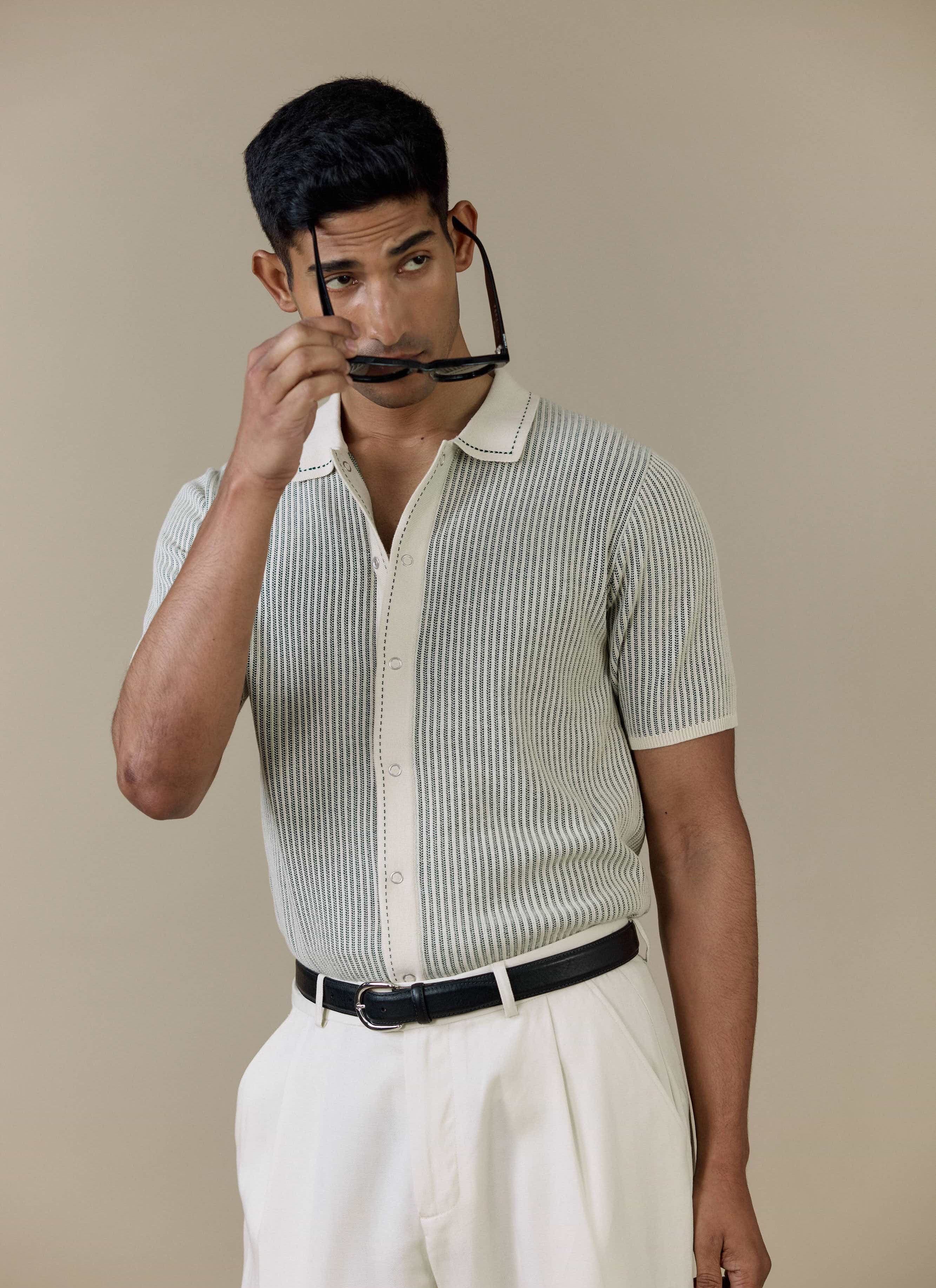 A model wearing the cream Percival Dixon Knitted Shirt, featuring a vertical stitch and button-through front.