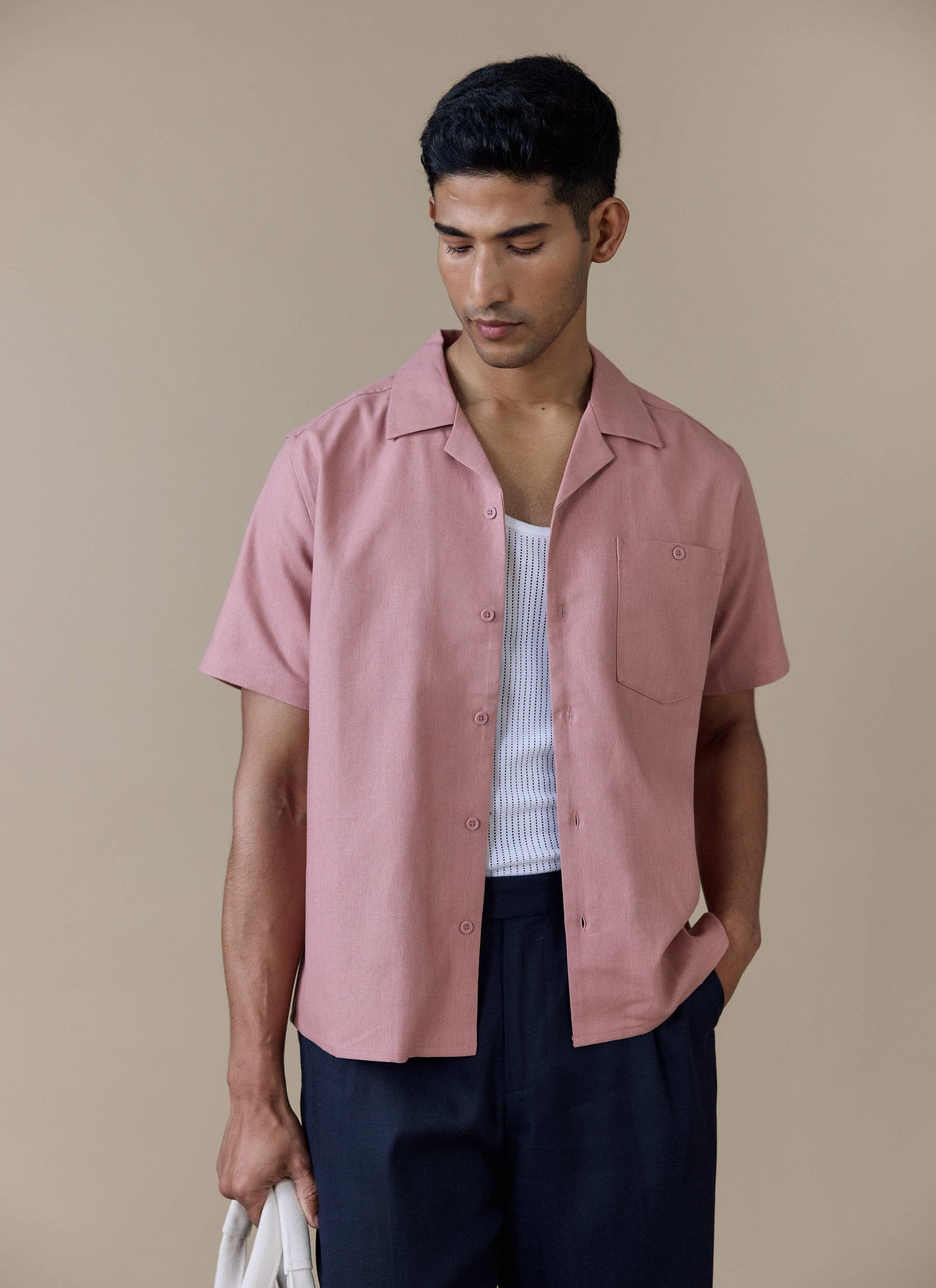 Model wears the Percival Short Sleeve Cuban Shirt in dusty pink linen blend over a white vest with a relaxed revere collar.