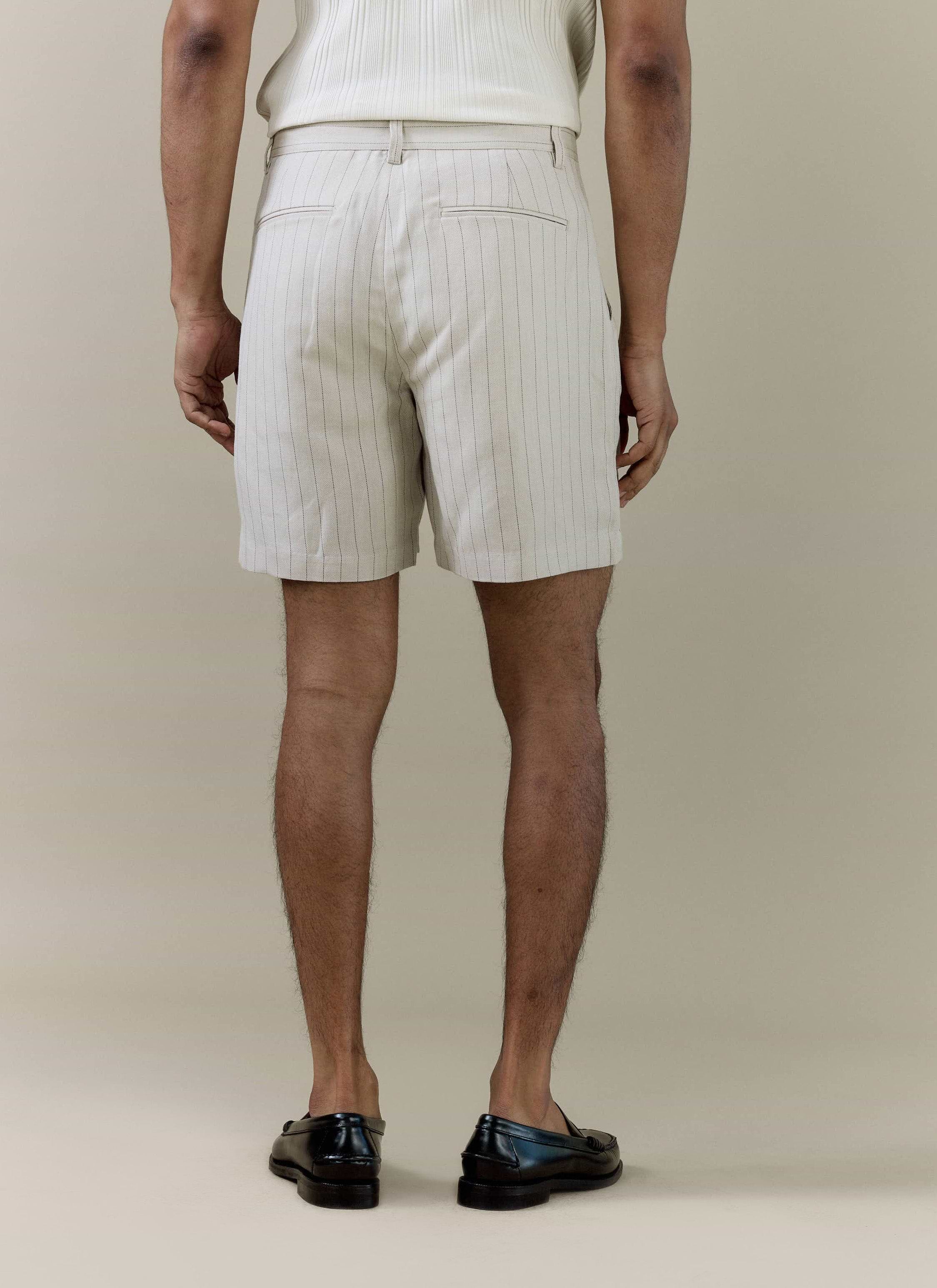 Rear view of Percival cream striped tailored shorts in a linen blend, showing pinstripes and back welt pockets.