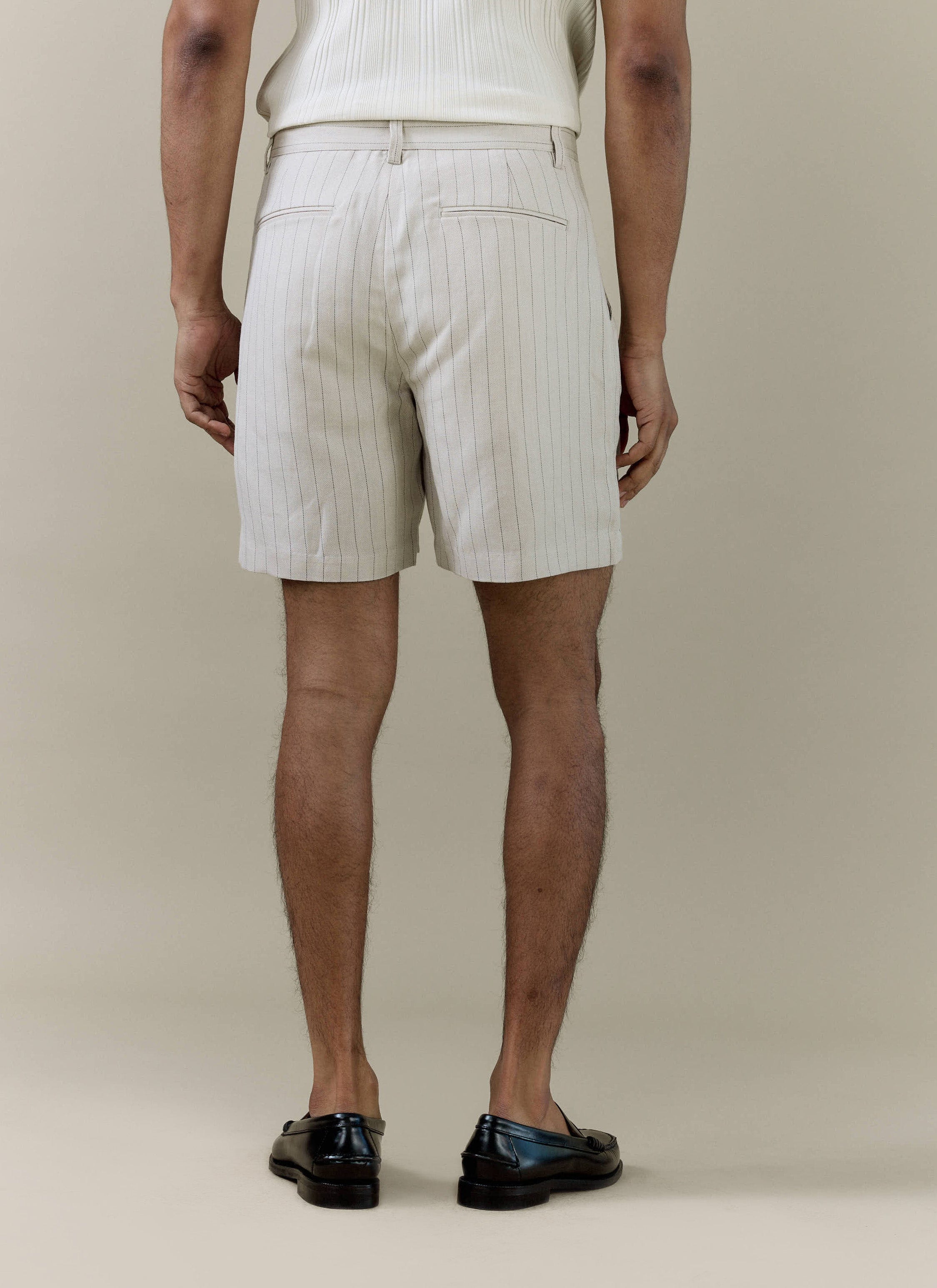 Rear view of Percival cream striped tailored shorts in a linen blend, showing pinstripes and back welt pockets.