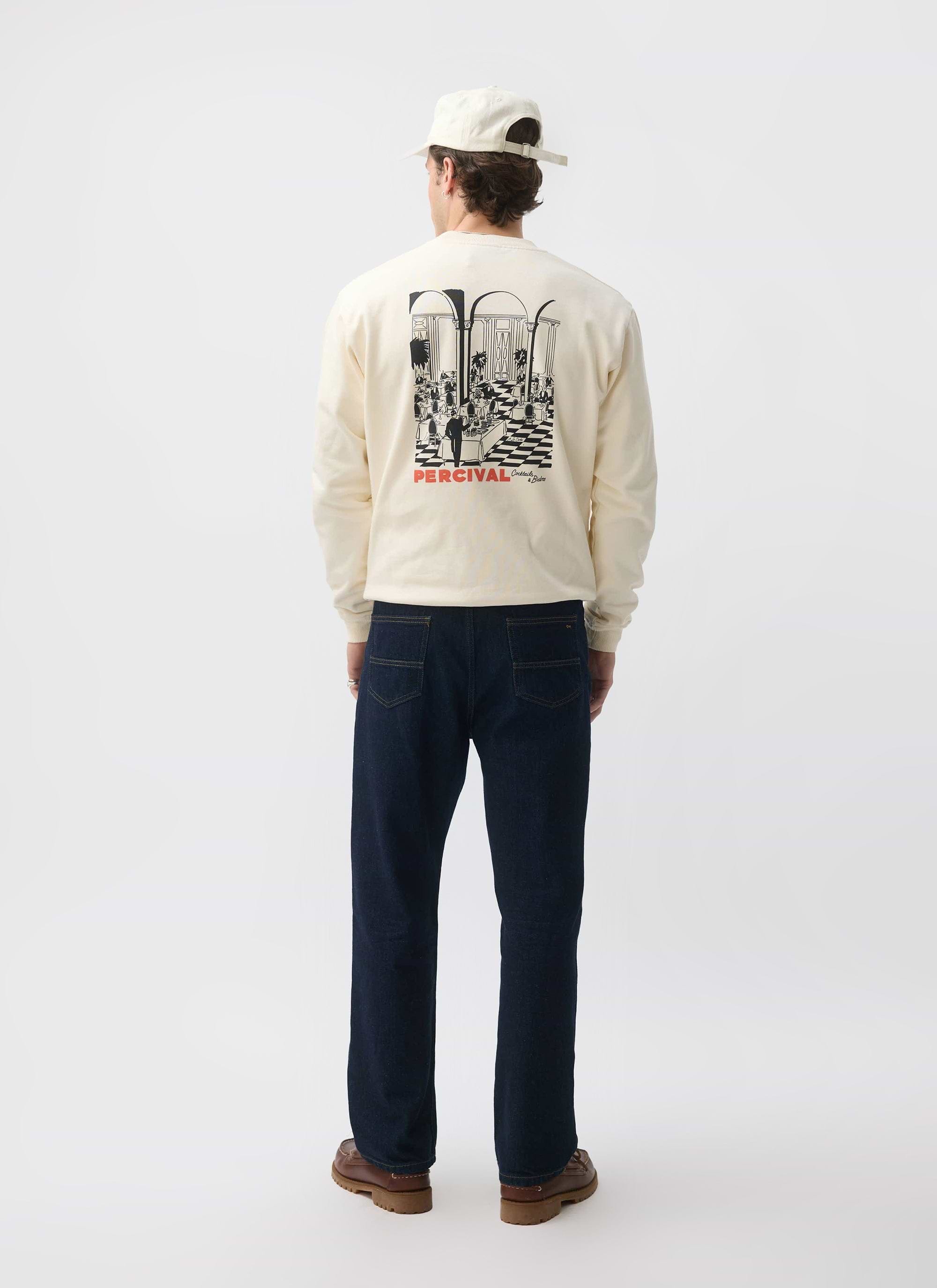 Rear view of a model wearing the Percival Bistro Printed Sweatshirt in ecru, showing the large back graphic.