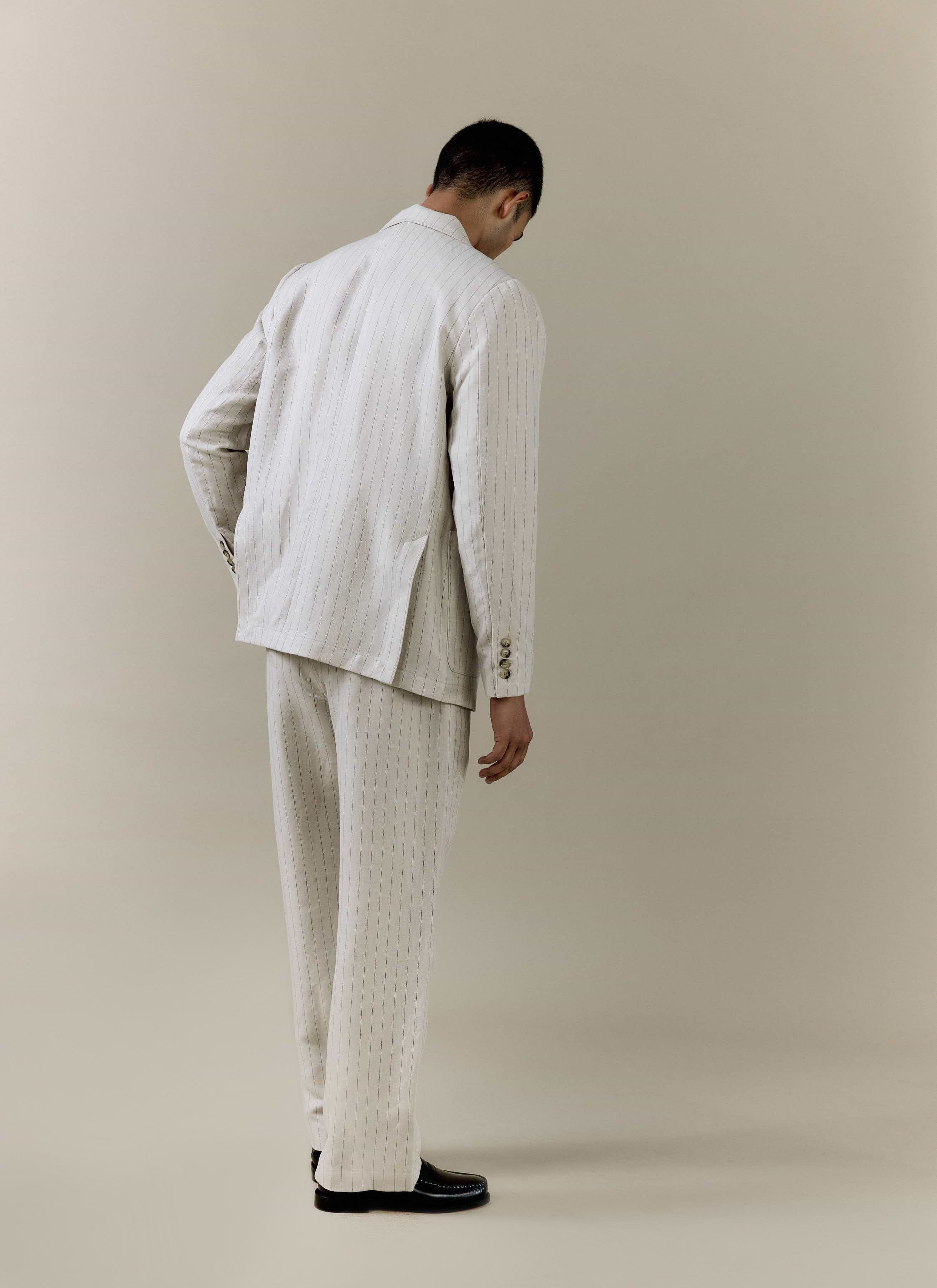 Rear view of the Percival cream pinstripe tailored blazer and trousers, crafted from a breathable linen blend.