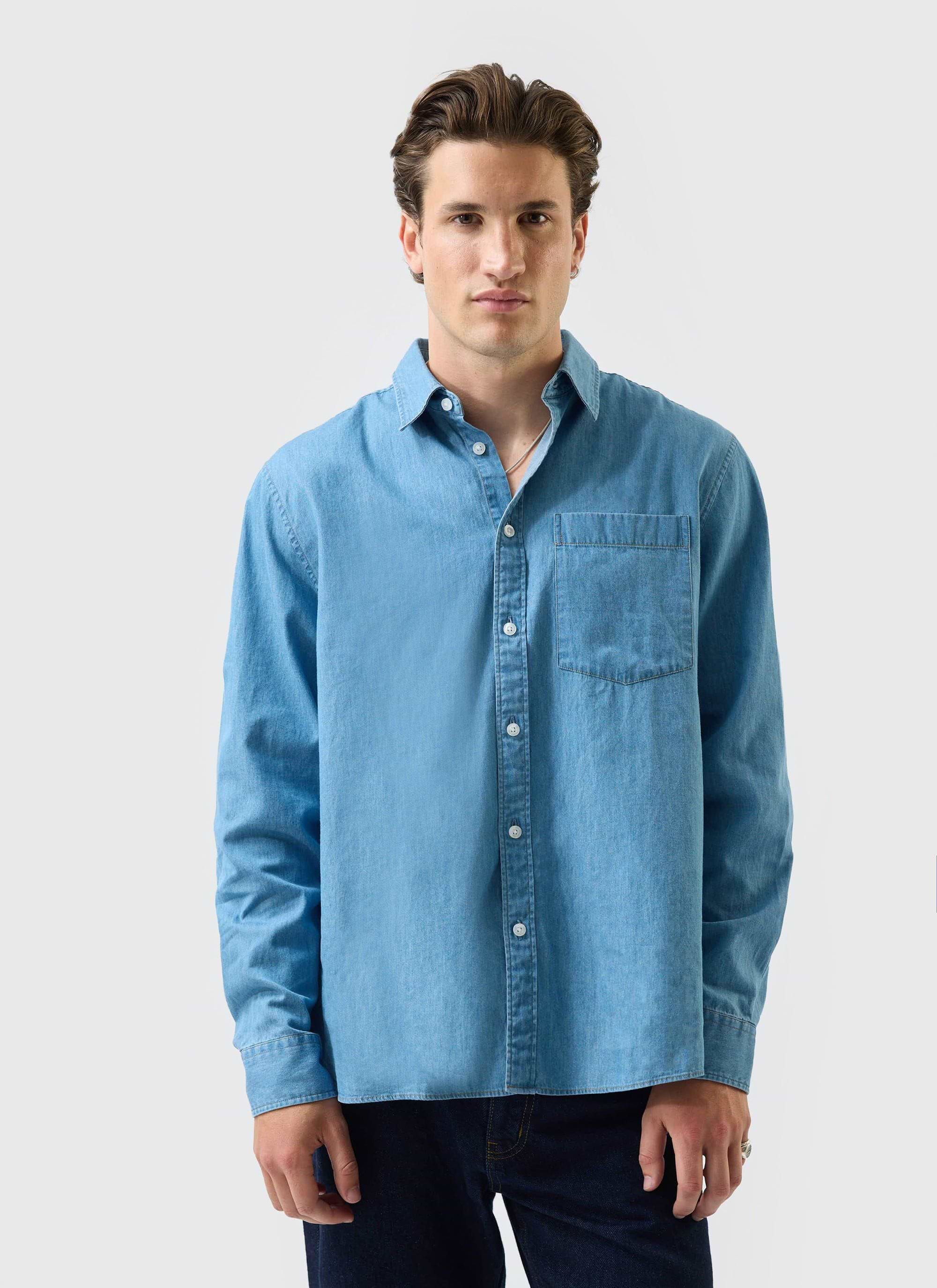 A model wears the Percival Marco Pearce denim shirt in a light blue wash against a white studio background.