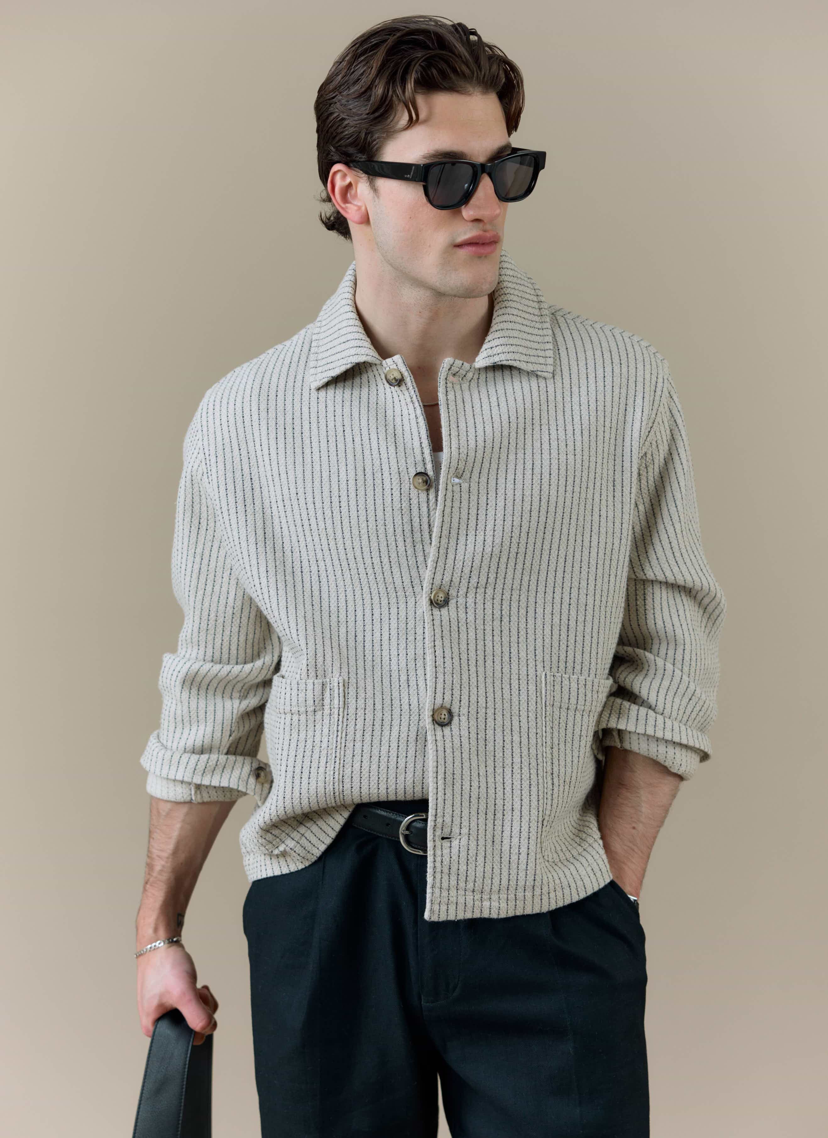 Model wearing the Percival Sorrento Boxy Overshirt in cream linen, featuring a vertical textured weave.