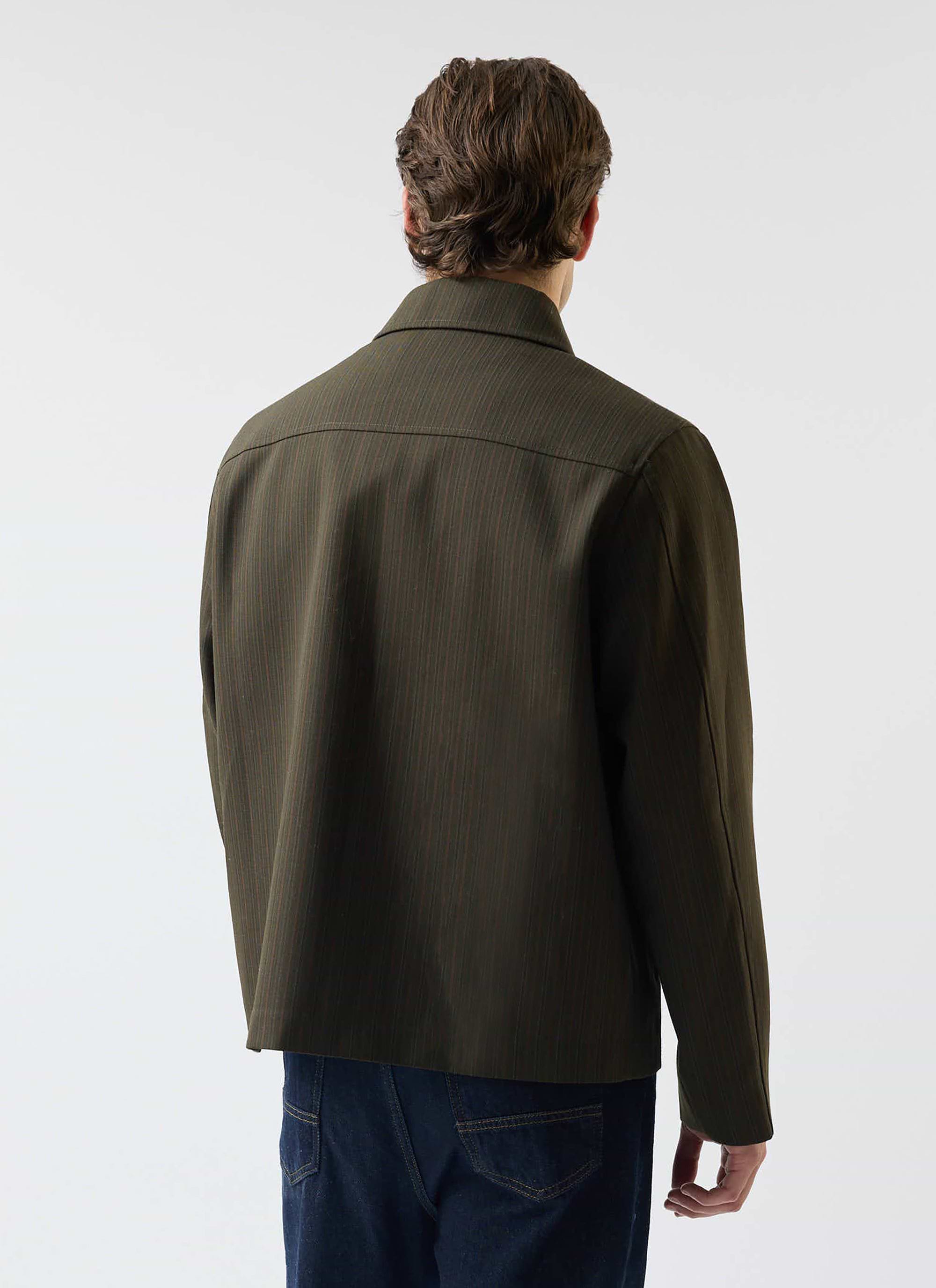 A man models the Percival Chapter Zip Up Jacket in Forest Green, showing the tailored fit from the back.