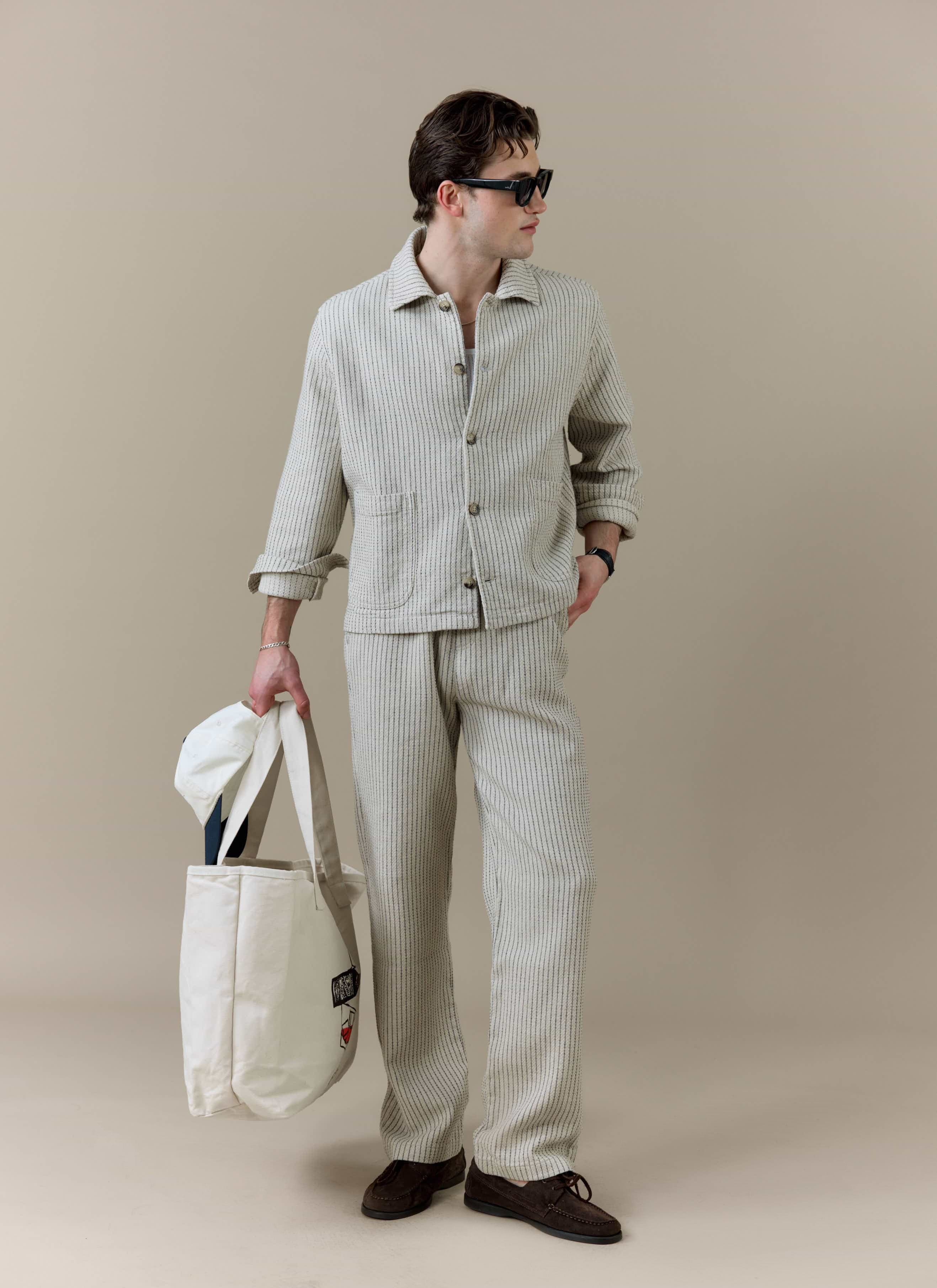 Model wearing the Percival Sorrento Boxy Overshirt and Wide Leg Trousers in cream textured linen as a co-ord set.