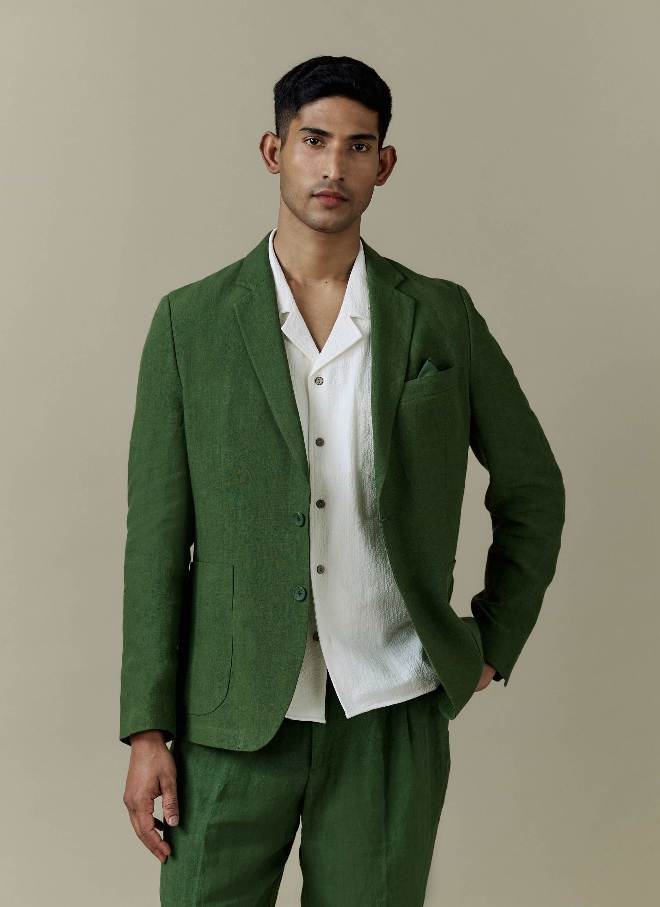 Percival forest green tailored linen blazer styled with matching trousers and a textured white shirt.