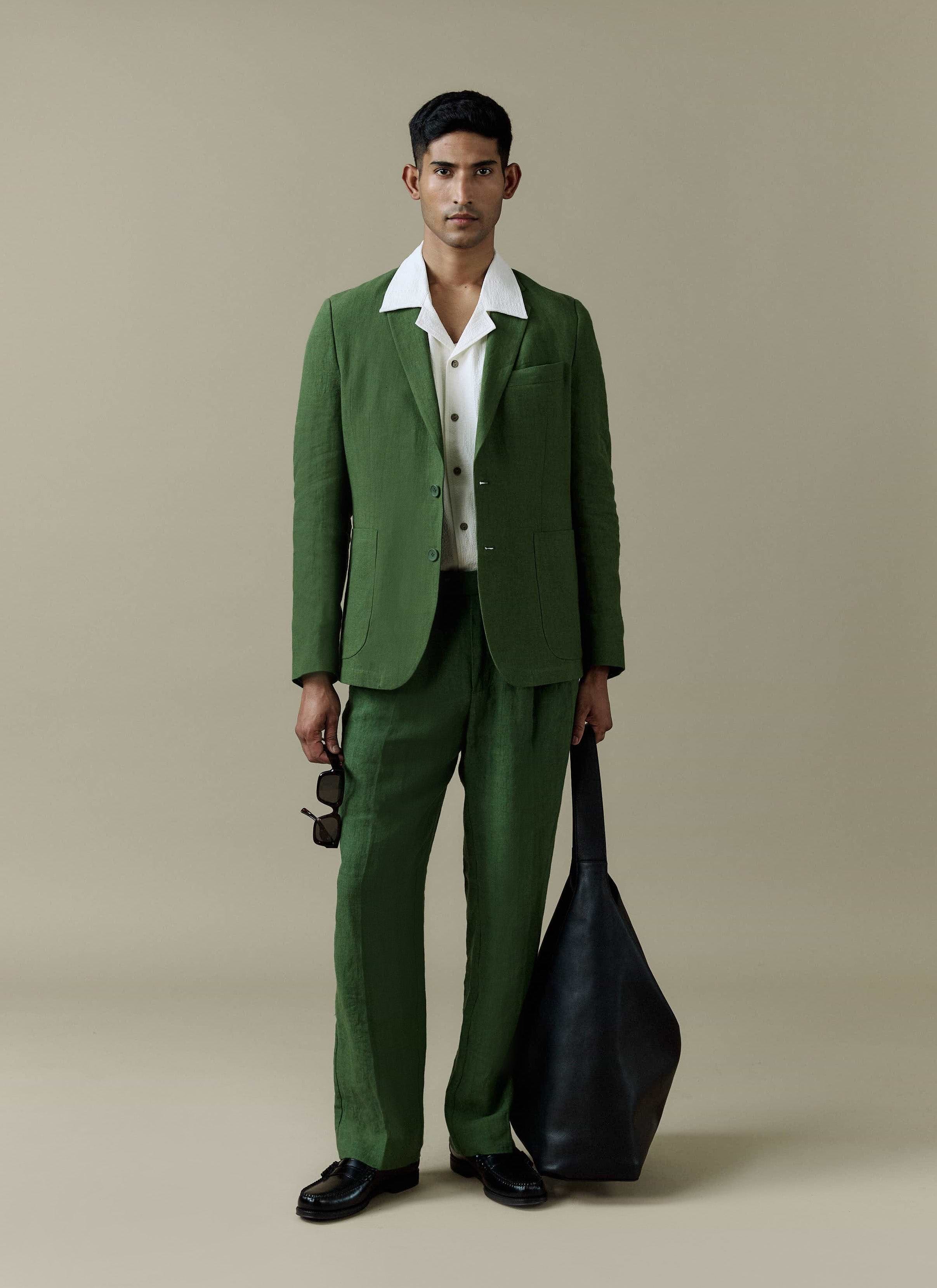 Percival Tailored Linen Blazer and matching trousers in forest green worn by a model with a white textured shirt.