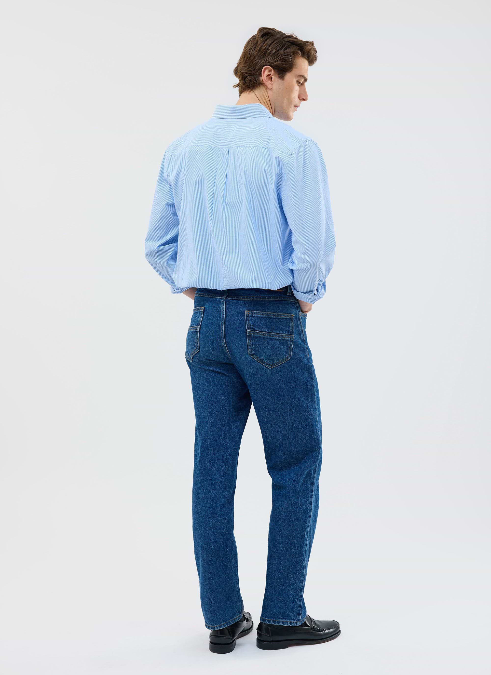 A man models the Percival Yacht Stripe Oversized Shirt in blue, showing the back view and relaxed fit on a white background.