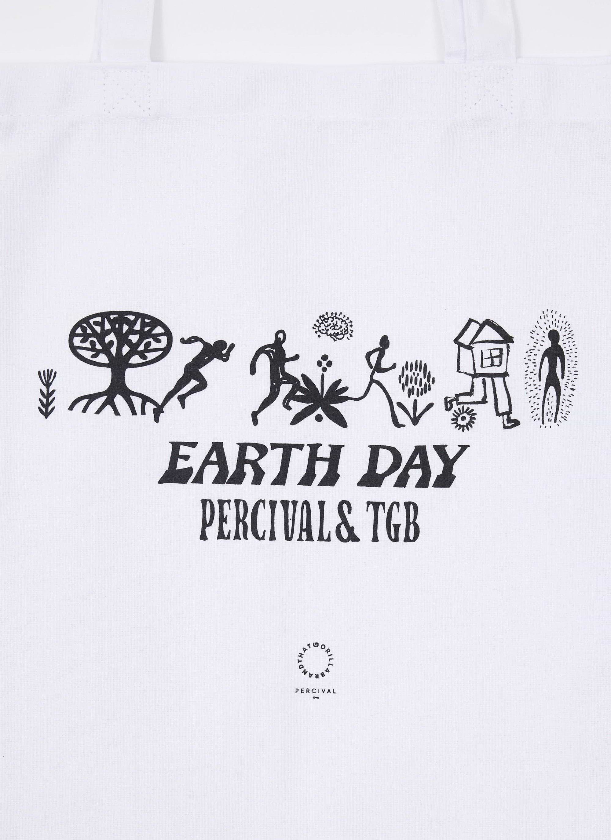 A close-up of the ecru tote bag from the Percival x The Gorilla Brand collaboration, showing the black 'Earth Day' graphic.